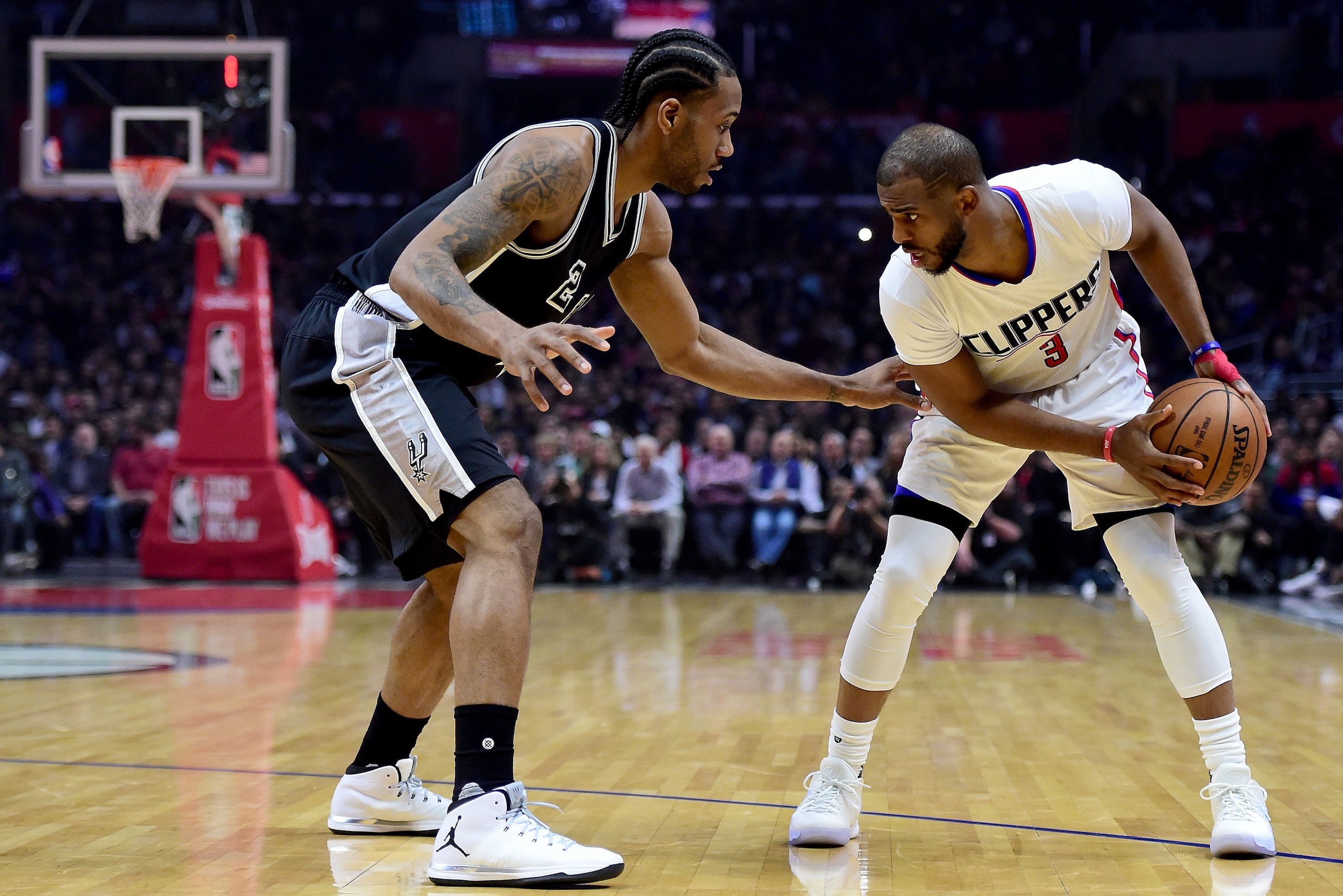 LOS ANGELES, CA - FEBRUARY 24:  Chris Paul #3 of the LA Clippers is guarded by Kawhi Leonard #2 of the San Antonio Spurs during the first half at Staples Center on February 24, 2017 in Los Angeles, California.  NOTE TO USER: User expressly acknowledges an