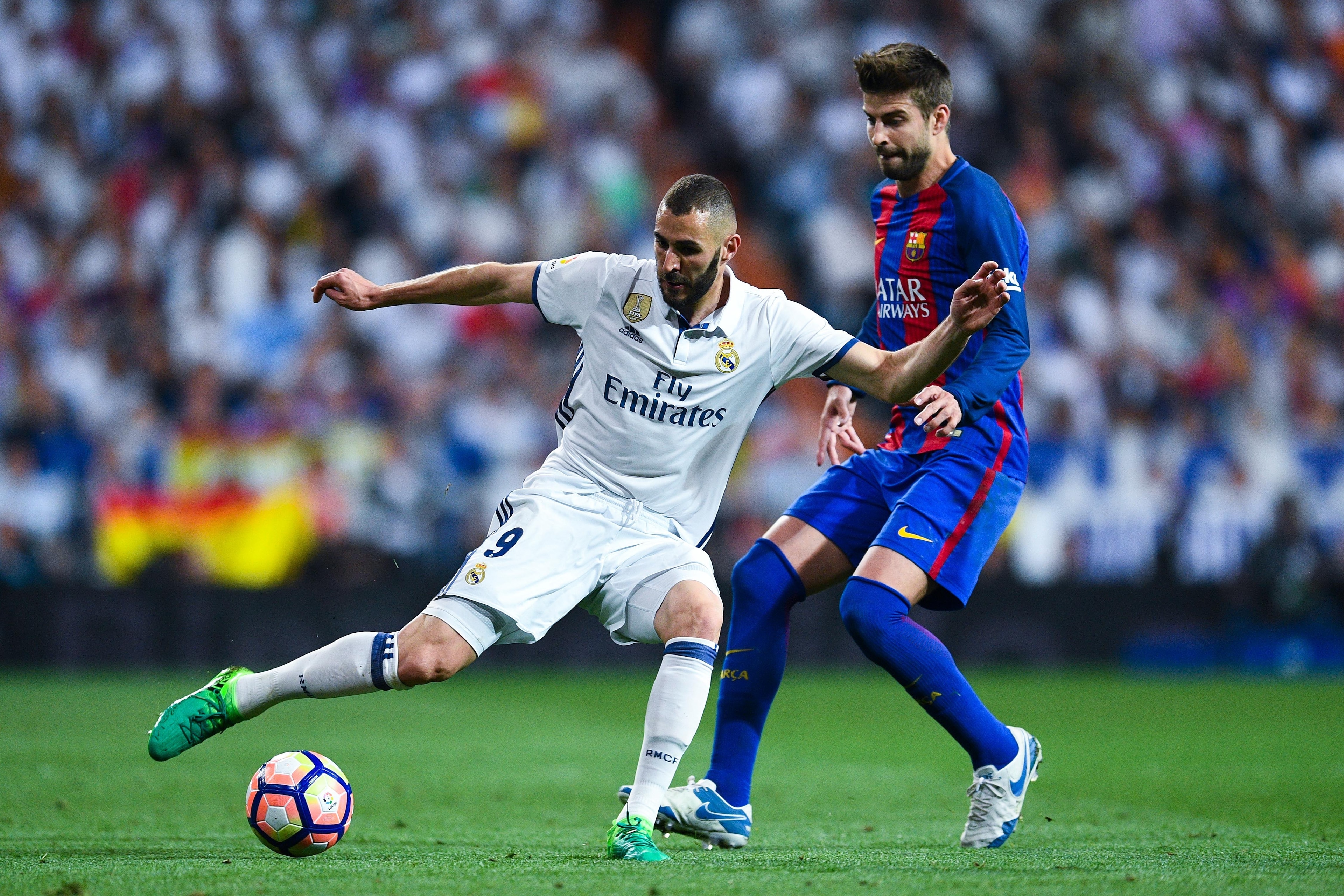 MADRID, SPAIN - APRIL 23: Karim Benzema of Real Madrid CF competes for the ball with Gerard Pique of FC Barcelona during the La Liga match between Real Madrid CF and FC Barcelona at the Santiago Bernabeu stadium on April 23, 2017 in Madrid, Spain. (Phot MADRID, SPAIN - APRIL 23: Karim Benzema of Real Madrid CF competes for the ball with Gerard Pique of FC Barcelona during the La Liga match between Real Madrid CF and FC Barcelona at the Santiago Bernabeu stadium on April 23, 2017 in Madrid, Spain. (Phot
