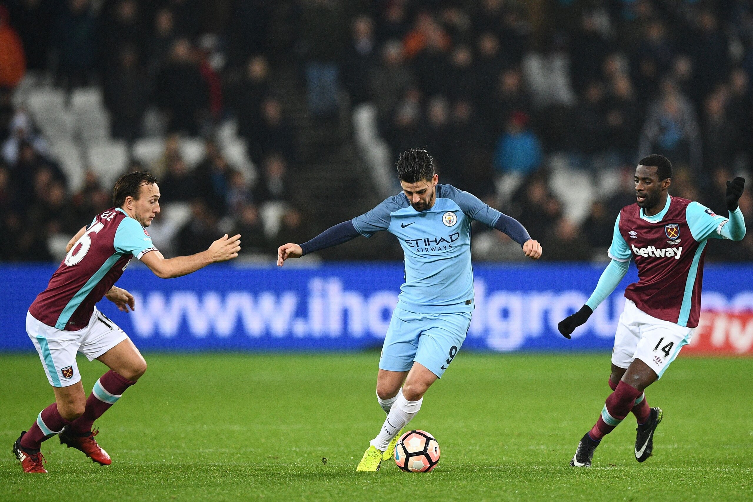 Manchester City's Spanish midfielder Nolito vies with West Ham United's English midfielder Mark Noble (L) and West Ham United's Spanish midfielder Pedro Obiang (R) during the English FA cup third round football match between West Ham United and Manchester