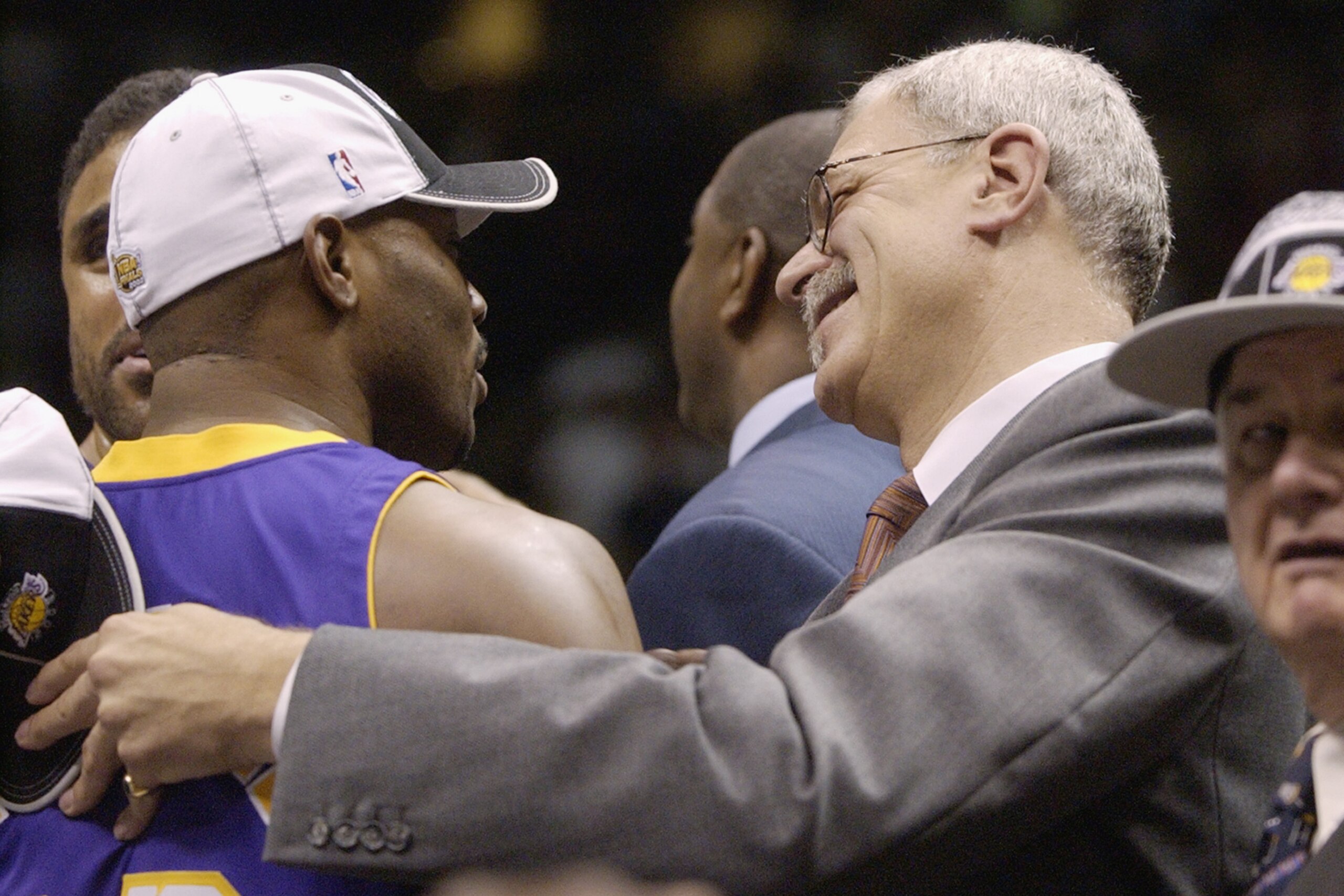EAST RUTHERFORD, NJ - JUNE 12: Head coach Phil Jackson of the Los Angeles Lakers celebrates with Mitch Richmond #23 of the Lakers after defeating the New Jersey Nets in Game four of the 2002 NBA Finals on June 12, 2002 at Continental Airlines Arena in Eas