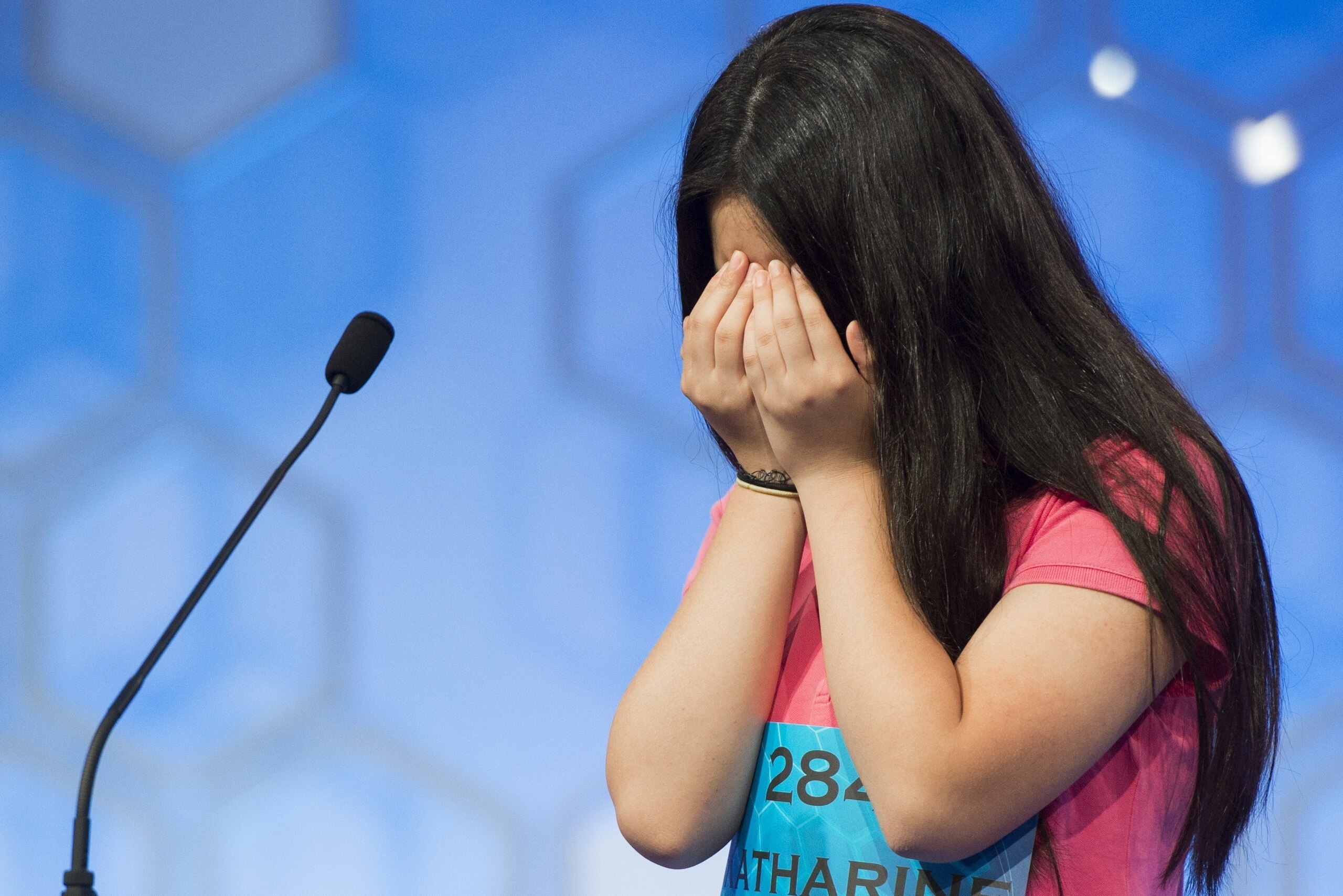 Katharine Wang of Morristown, New Jersey, reacts after hearing her word during the semifinal round of the 88th Annual Scripps National Spelling Bee at National Harbor in Oxon Hill, Maryland, May 28, 2015. AFP PHOTO / SAUL LOEB        (Photo credit should 