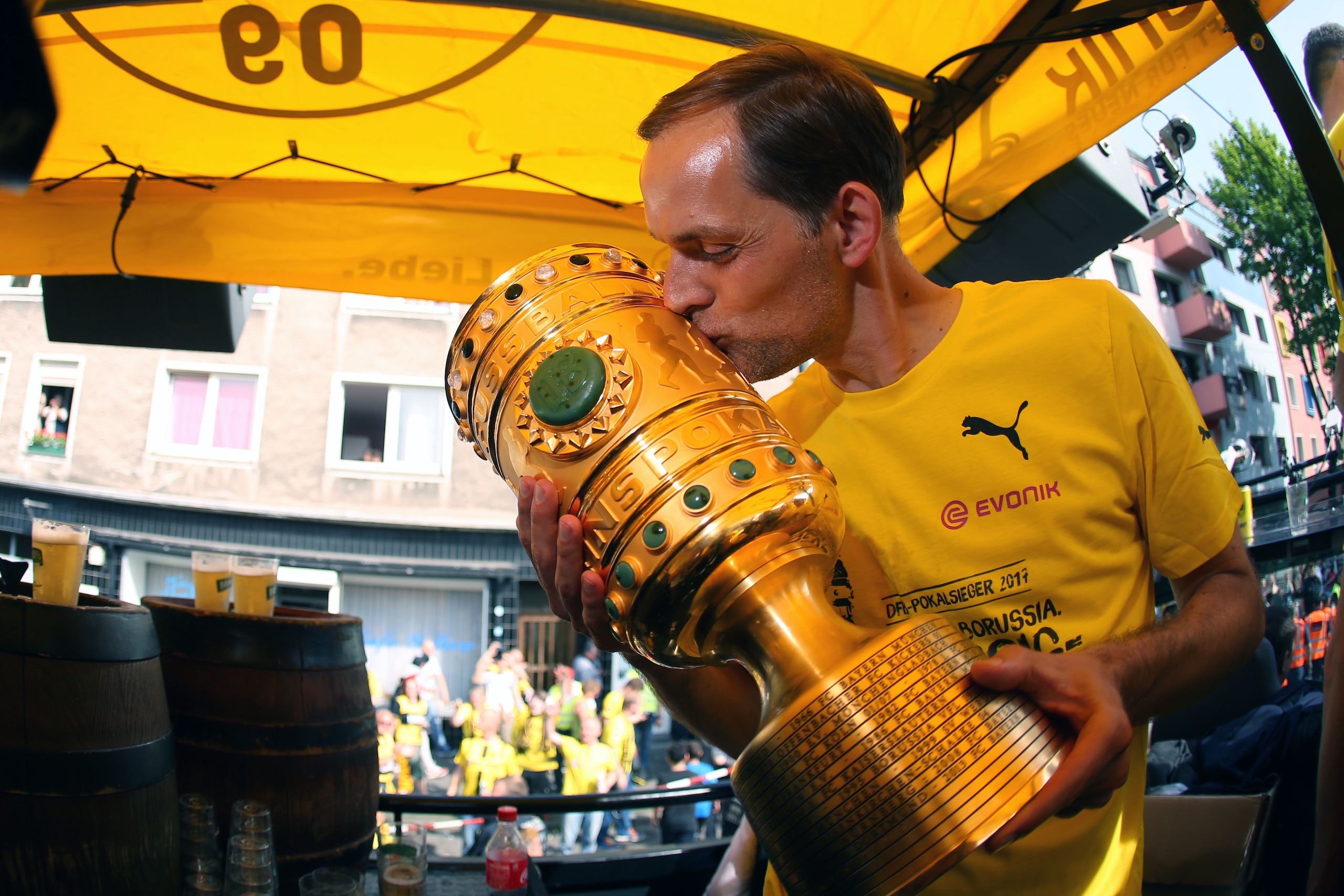 Dortmund's head coach Thomas Tuchel kisses the trophy as they arrive at Borsigplatz during celebrations after winning the German Cup final (DFB Pokalfinale) in Dortmund, western Germany, on May 28, 2017. / AFP PHOTO / POOL / Ina FASSBENDER        (Photo c