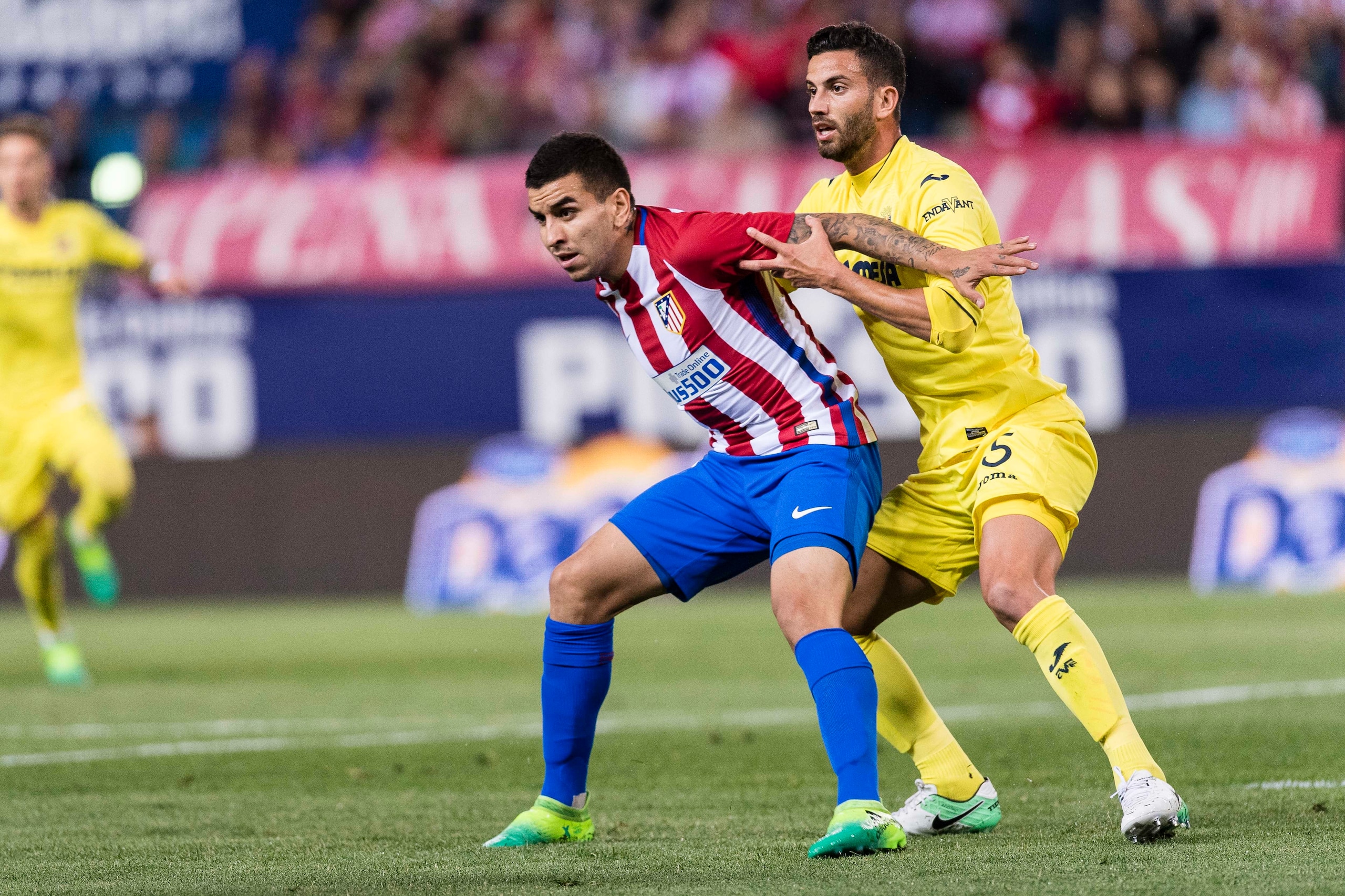 MADRID, SPAIN - APR 25: Angel Correa of Atletico de Madrid (L) and Mateo Pablo Musacchio of Villarreal CF (R) in action during the La Liga match between Atletico de Madrid vs Villarreal CF at the Estadio Vicente Calderon on 25 April 2017 in Madrid, Spain.