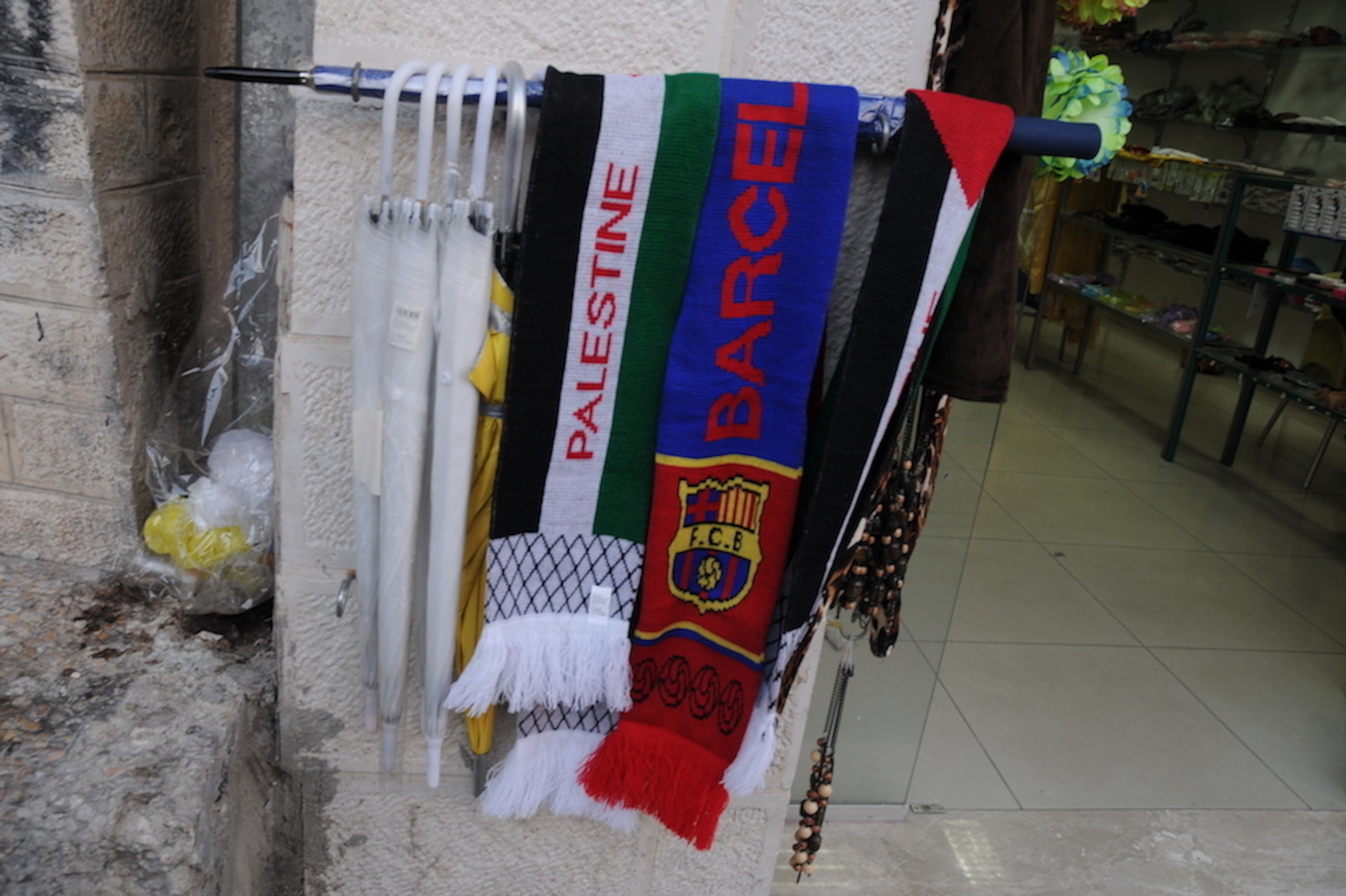 Palestine and Barcelona scarves hang side by side in the West Bank.