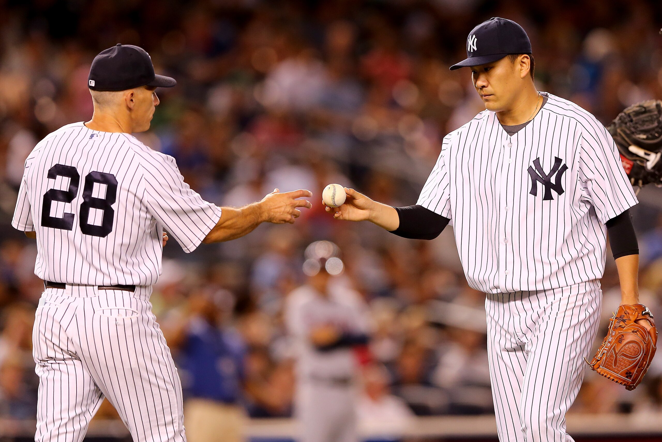 NEW YORK, NY - AUGUST 21:  Manager Joe Girardi #28 of the New York Yankees pulls Masahiro Tanaka #19 in the seventh inning against the Cleveland Indians on August 21, 2015 at Yankee Stadium in the Bronx borough of New York City.  (Photo by Elsa/Getty Imag