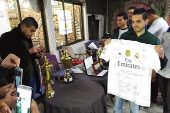 Abo Habil with his signed Real Madrid shirt.