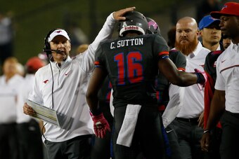 Coach Chad Morris (left) and Sutton (16).