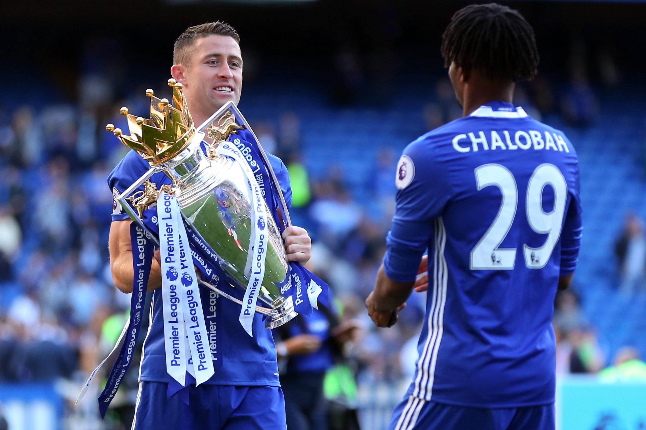 LONDON, ENGLAND - MAY 21: Gary Cahill of Chelsea hands the Premier League trophy to Nathaniel Chalobah of Chelsea during the Premier League match between Chelsea and Sunderland at Stamford Bridge on May 21, 2017 in London, England. (Photo by Catherine Ivi