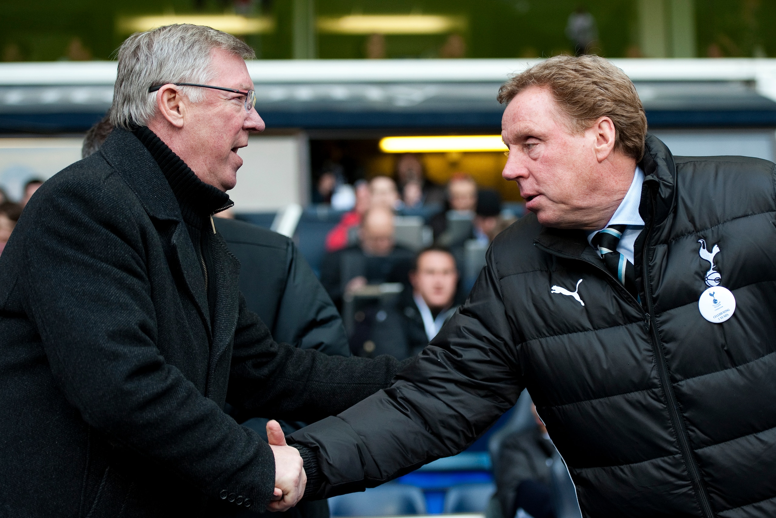 Manchester United's Manager Alex Ferguson (L) shakes hands with Tottenham Hotspurs' Manager Harry Redknapp (R) ahead of the Premiership football match at White Hart Lane Park in London on March 4, 2012. Manchester United won the game 3-1. AFP PHOTO / ADRI