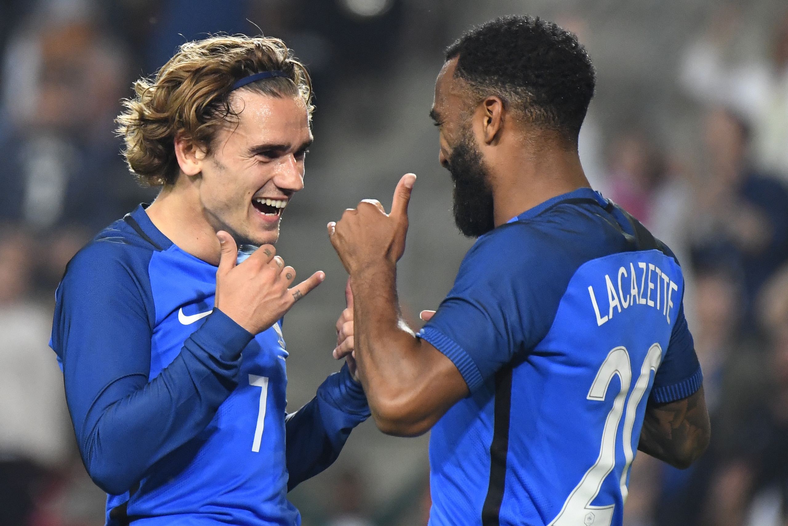 France's forward Antoine Griezmann (L) celebrates with France's forward Alexandre Lacazette after scoring a goal during the friendly football match between France and Paraguay on June 2, 2017 at the Roazhon park stadium in Rennes, western France. / AFP PH