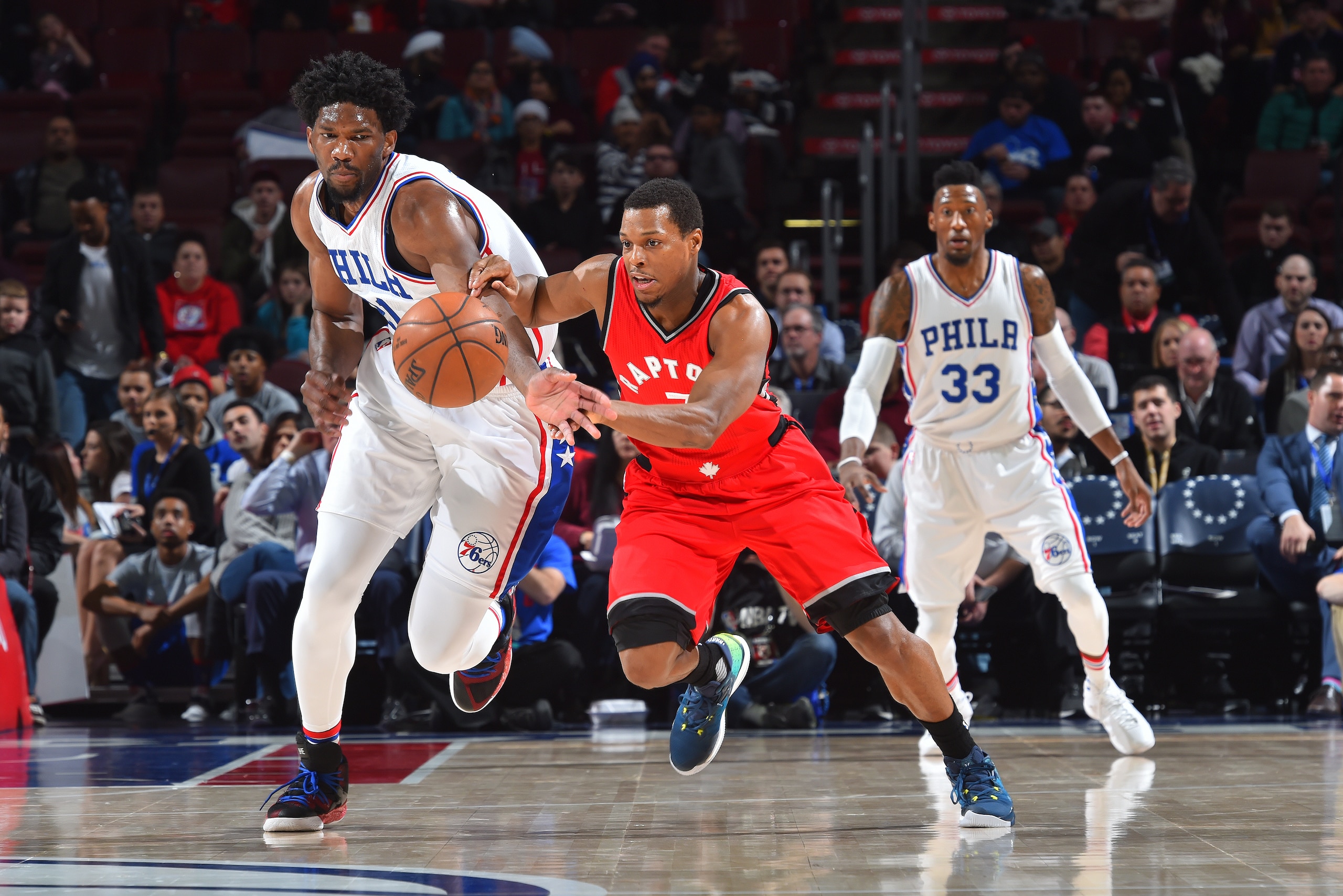 PHILADELPHIA,PA - DECEMBER 14: Joel Embiid #21 of the Philadelphia 76ers goes after a loose ball against Kyle Lowry #7 of the Toronto Raptors at Wells Fargo Center on December 14, 2016 in Philadelphia, Pennsylvania NOTE TO USER: User expressly acknowledge