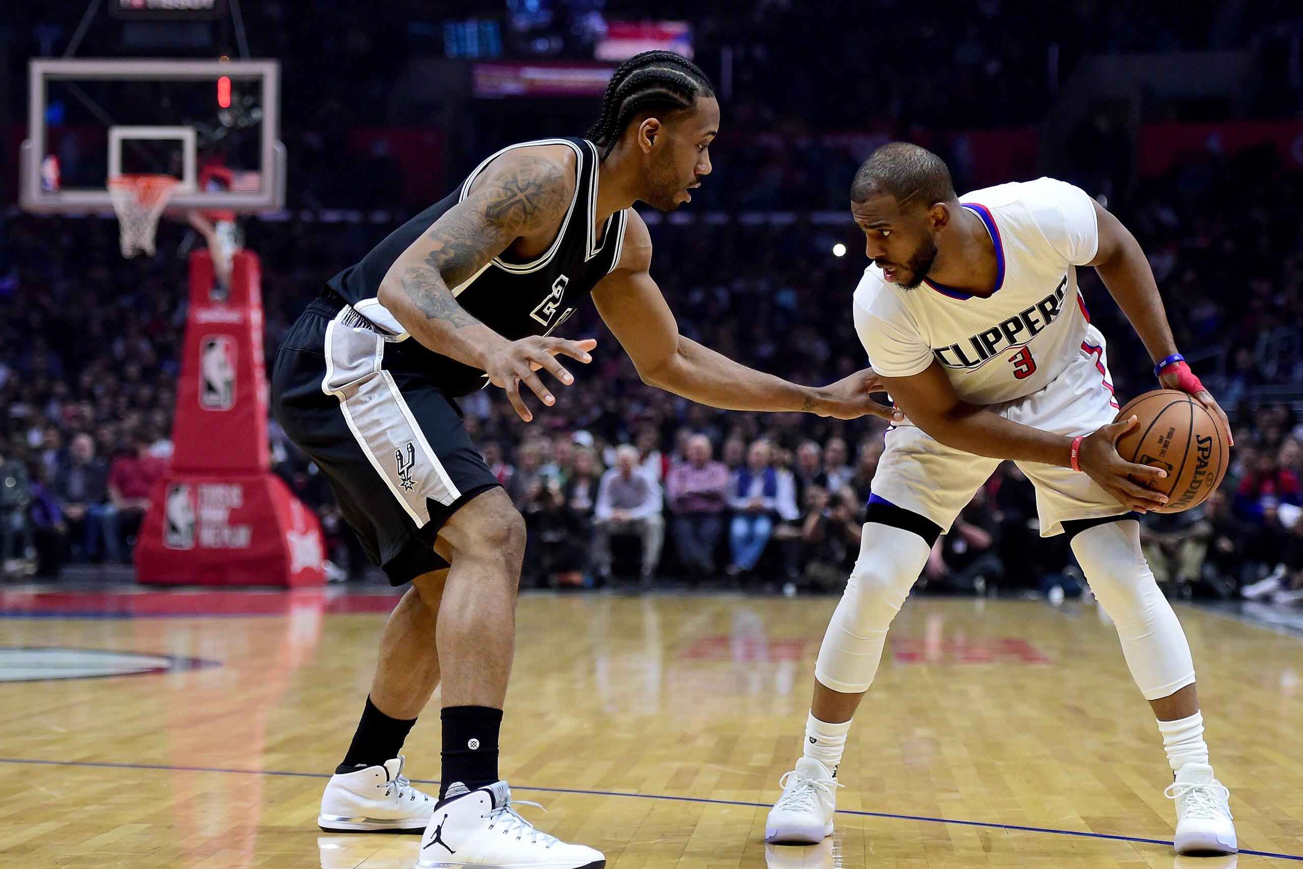 LOS ANGELES, CA - FEBRUARY 24:  Chris Paul #3 of the LA Clippers is guarded by Kawhi Leonard #2 of the San Antonio Spurs during the first half at Staples Center on February 24, 2017 in Los Angeles, California.  NOTE TO USER: User expressly acknowledges an