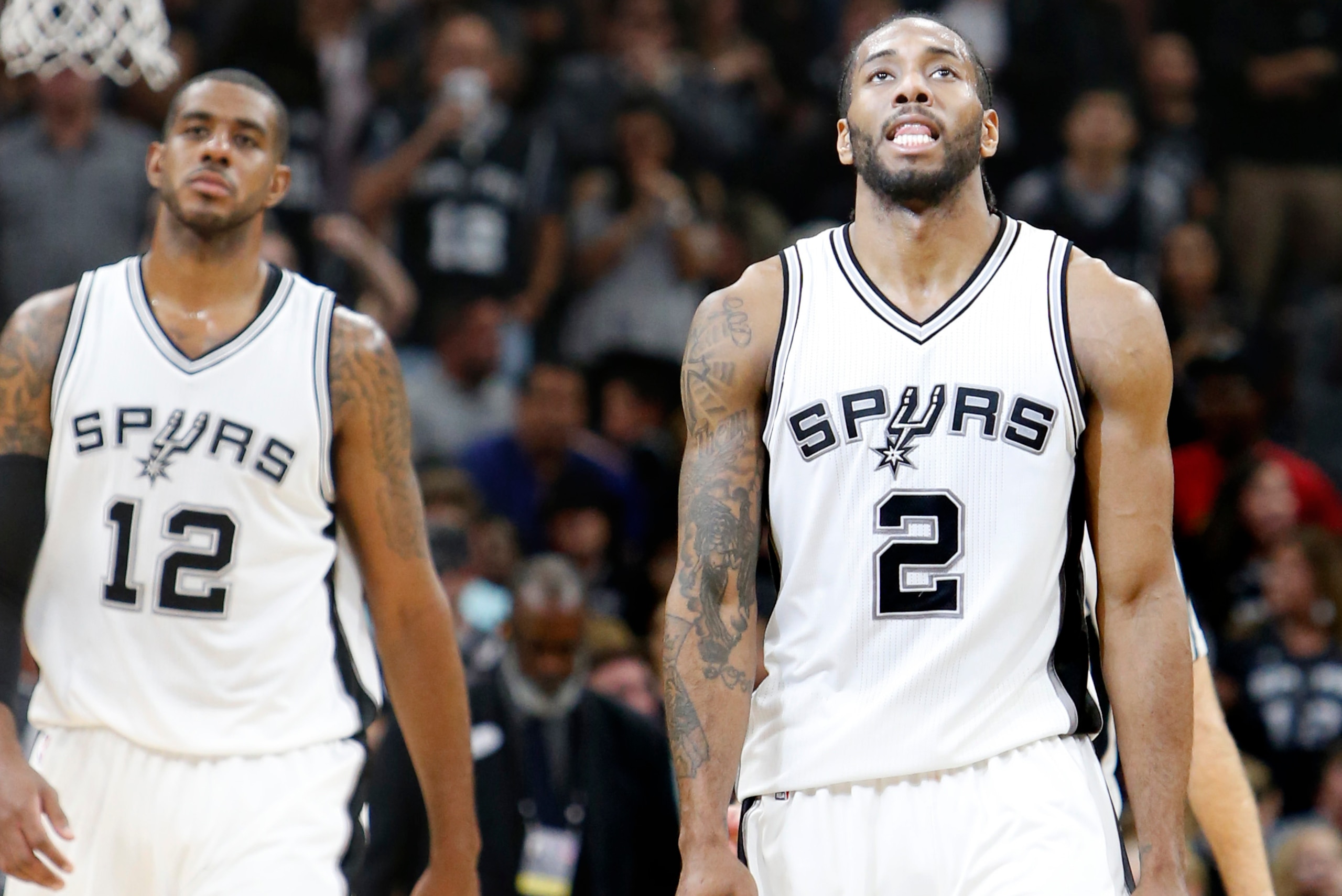 SAN ANTONIO,TX - MARCH 15: LaMarcus Aldridge #12 of the San Antonio Spurs and Kawhi Leonard #2 of the San Antonio Spurs walk off the court late in game against the Portland Trail Blazers at AT&T Center on March 15, 2017 in San Antonio, Texas.  NOTE TO USE