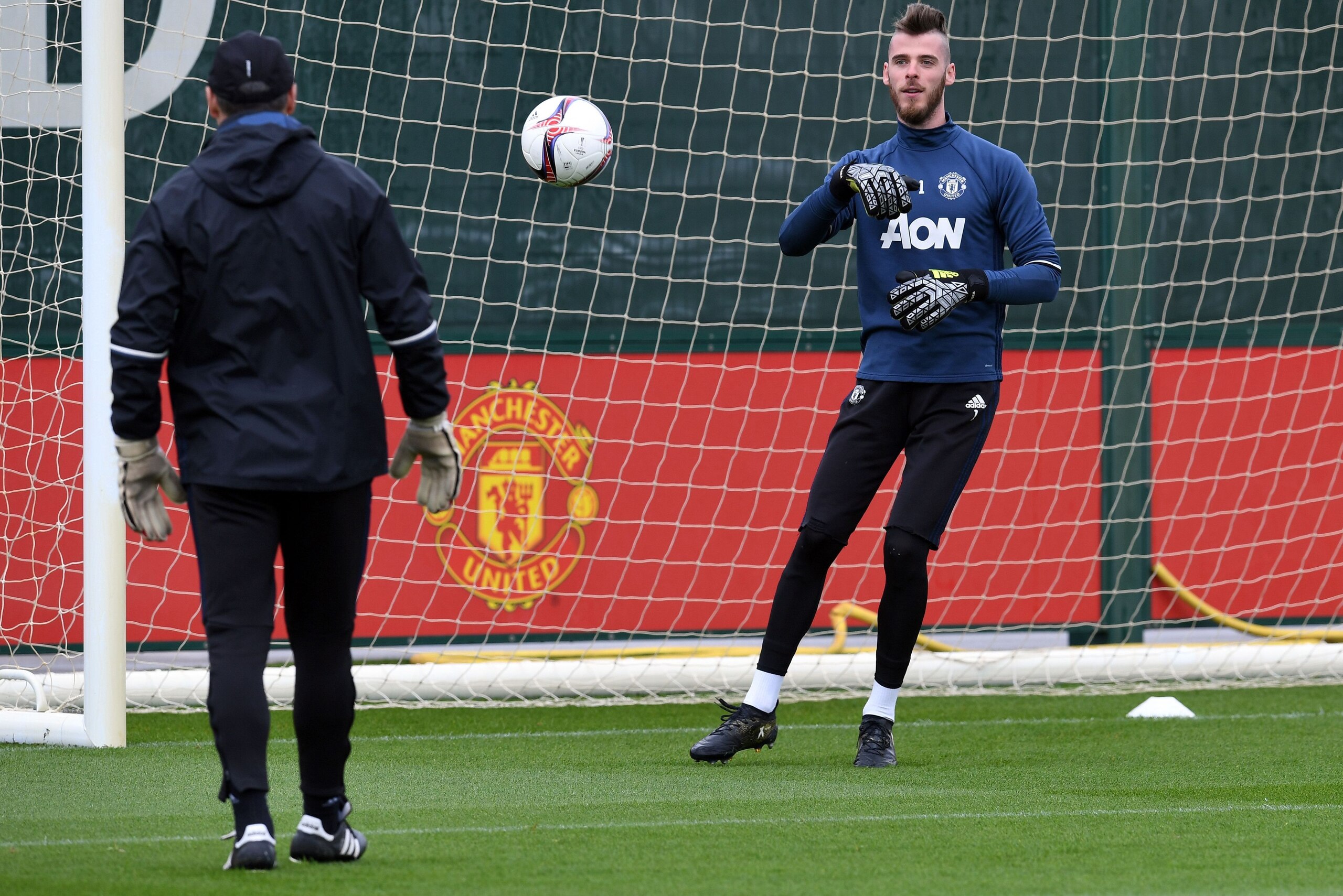 Manchester United's Spanish goalkeeper David de Gea (R) attends a team training session as part of a media open day at the club's training complex near Carrington, west of Manchester in north west England on May 19, 2017, ahead of their UEFA Europa League