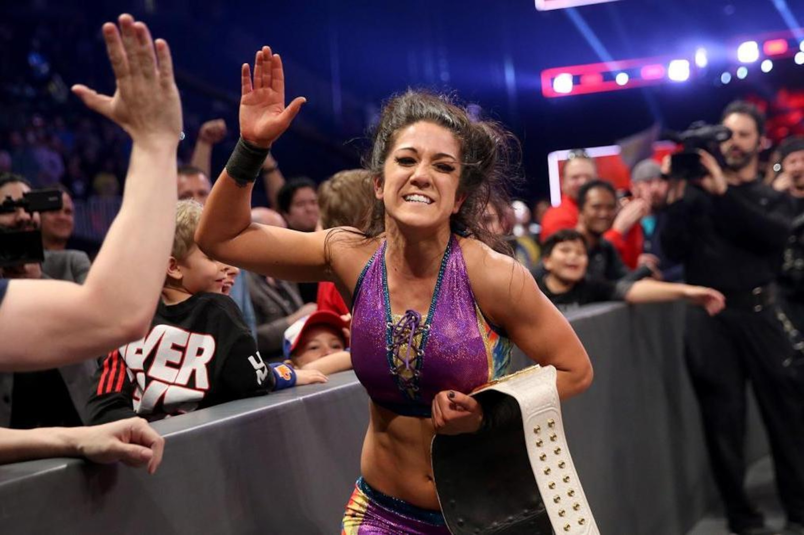 Bayley celebrates dethroning Charlotte Flair in February.