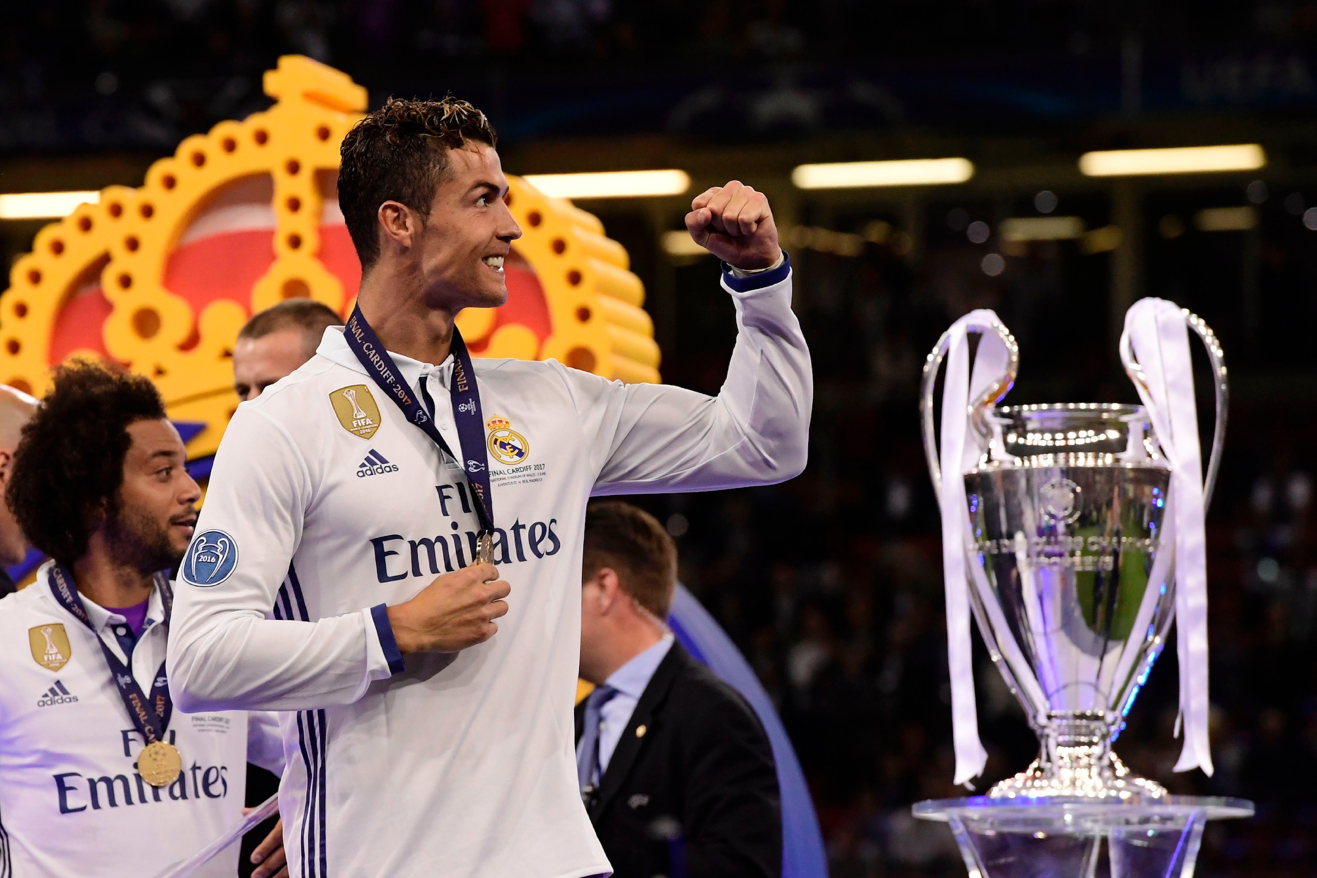 Real Madrid's Portuguese striker Cristiano Ronaldo celebrates next to the trophy after Real Madrid won the UEFA Champions League final football match between Juventus and Real Madrid at The Principality Stadium in Cardiff, south Wales, on June 3, 2017. / Real Madrid's Portuguese striker Cristiano Ronaldo celebrates next to the trophy after Real Madrid won the UEFA Champions League final football match between Juventus and Real Madrid at The Principality Stadium in Cardiff, south Wales, on June 3, 2017. /