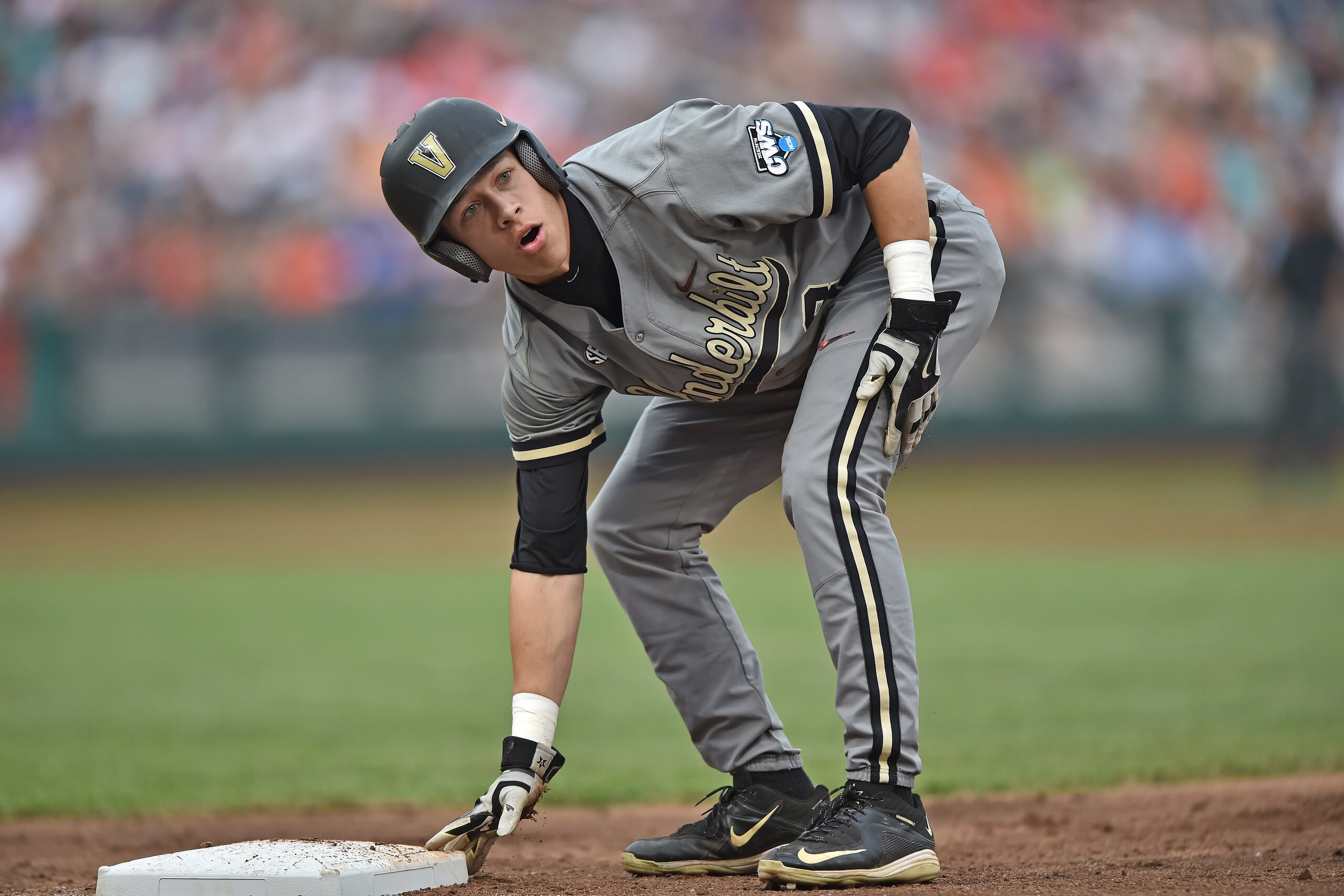 Omaha, NE - JUNE 23:  Base runner Jeren Kendall #3 of the Vanderbilt Commodores reacts after getting picked off of first base against the Virginia Cavaliers in the second inning during game two of the College World Series Championship Series on June 23, 2