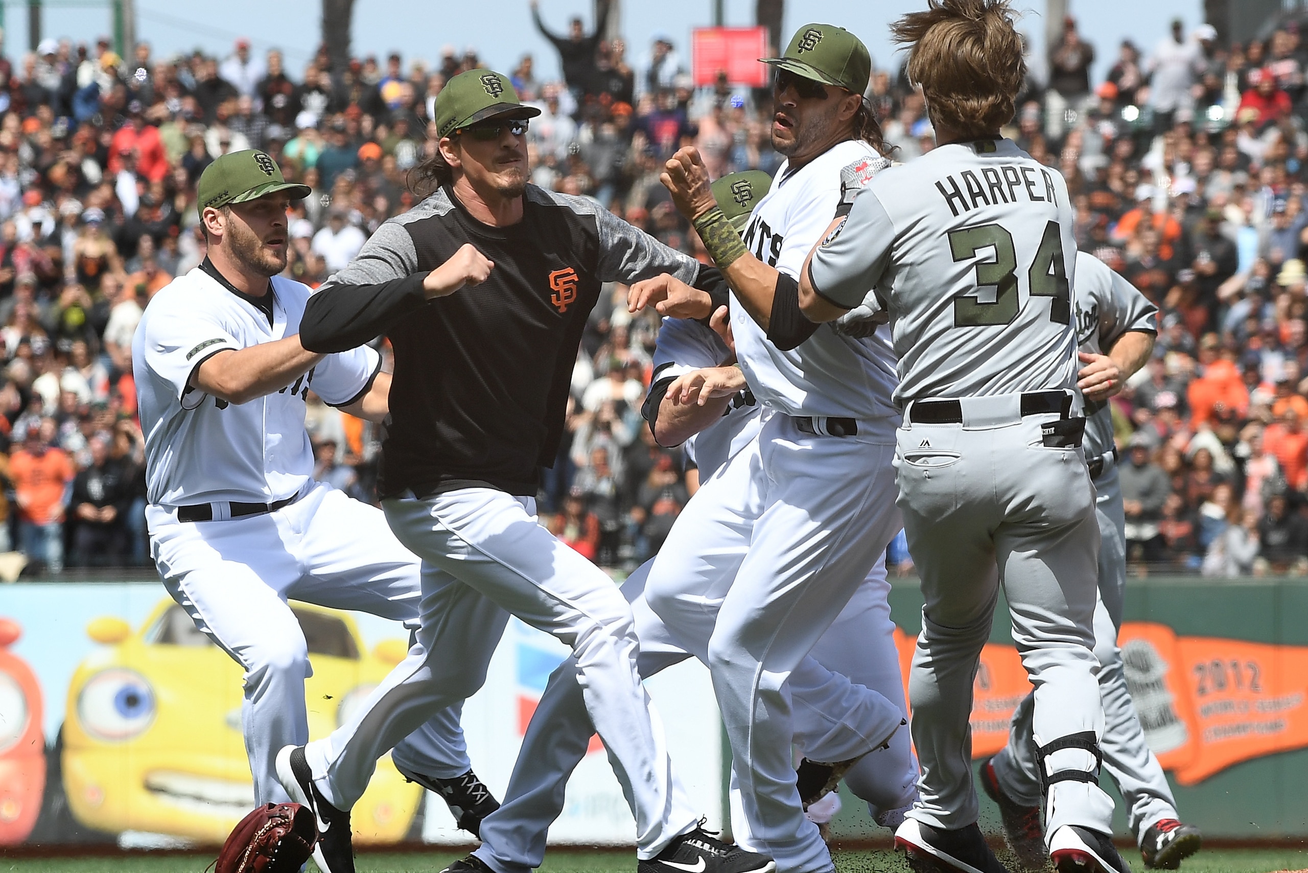 SAN FRANCISCO, CA - MAY 29:  Jeff Samardzija #29 of the San Francisco Giants goes after Bryce Harper #34 of the Washington Nationals after Harper charged the mound from being hit by a pitch from Hunter Strickland #60 in the top of the eighth inning at AT&
