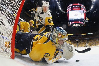 NASHVILLE, TN - JUNE 05:  Pekka Rinne #35 of the Nashville Predators makes a glove save against Jake Guentzel #59 of the Pittsburgh Penguins during the second period in Game Four of the 2017 NHL Stanley Cup Final at the Bridgestone Arena on June 5, 2017 i