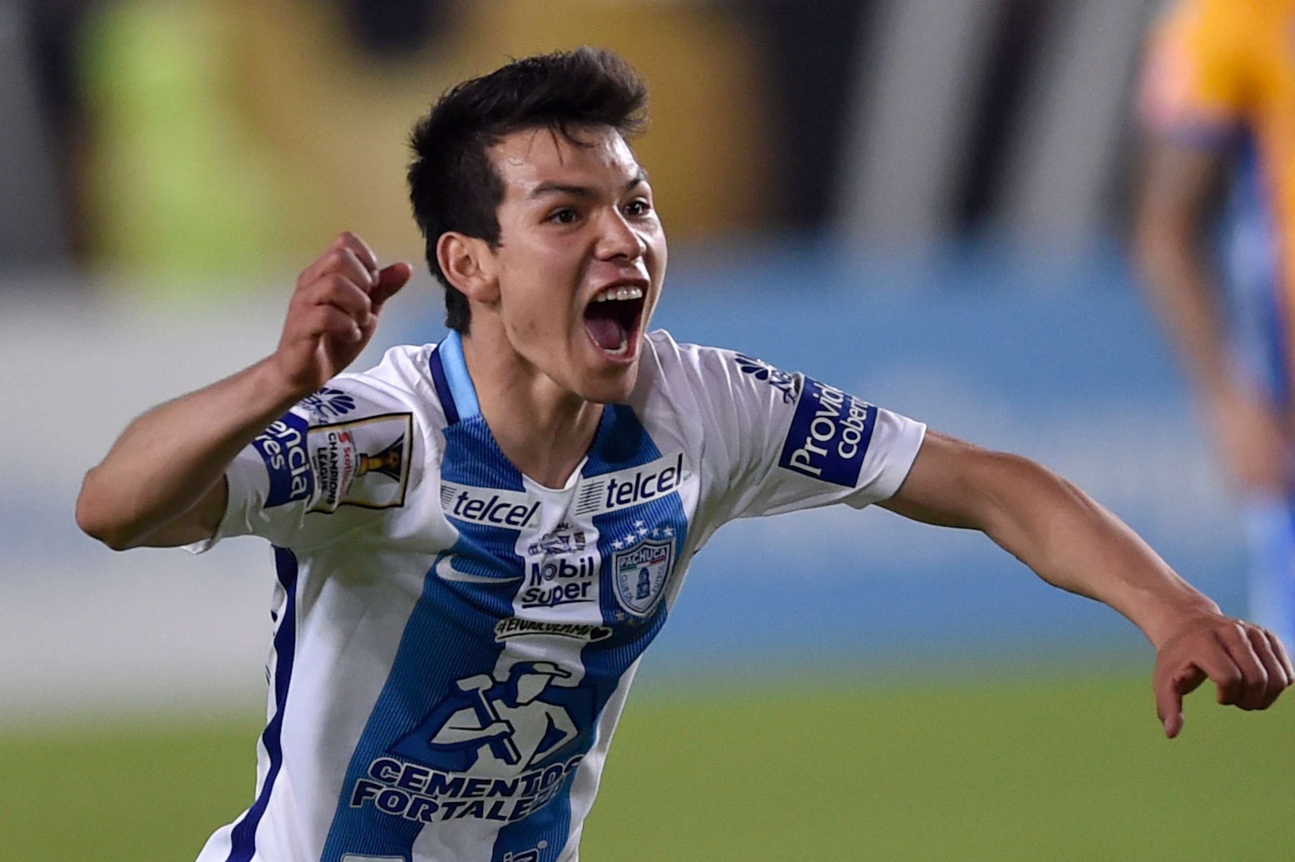Mexico´s Pachuca Hirving Lozano (L) celebrates the goal of his teammate Franco Jara (out of frame)against Mexico´s Tigres during their CONCACAF Champions League Final match at the Hidalgo stadium in Pachuca, Hidalgo state, Mexico on April 26, 2017. / AFP 