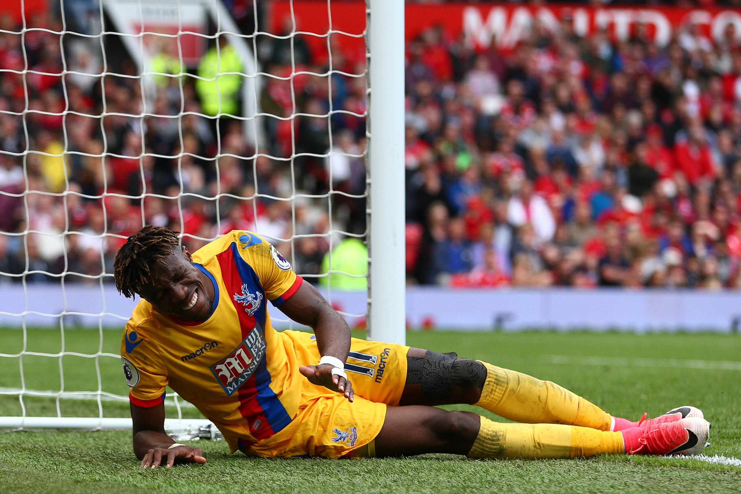 MANCHESTER, ENGLAND - MAY 21: Wilfried Zaha of Crystal Palace lies injured during the Premier League match between Manchester United and Crystal Palace at Old Trafford on May 21, 2017 in Manchester, England. (Photo by Dave Thompson/Getty Images)
