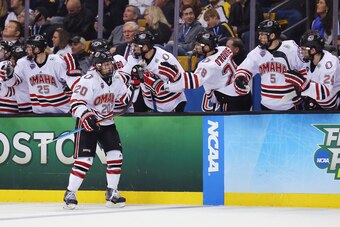 BOSTON, MA - APRIL 09:  Jake Guentzel #20 of the Nebraska-Omaha Mavericks is congratulated by teammates after scoring against the Providence Friars during the third period of the 2015 NCAA Division I Men's Hockey Championship semifinals at TD Garden on Ap