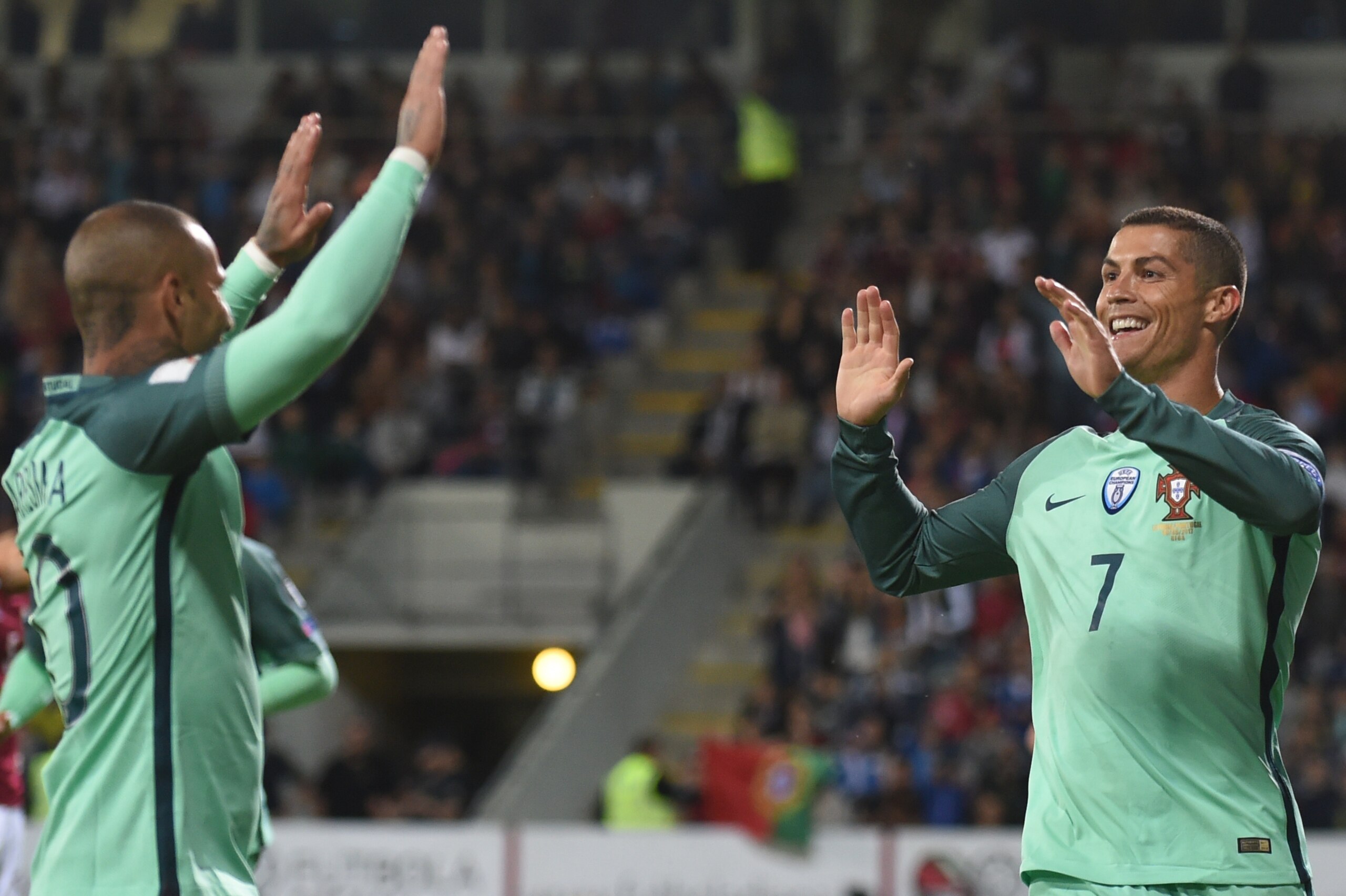 Portugal's forward Cristiano Ronaldo (R) celebrate scoring with Portugal's forward Ricardo Quaresma during the FIFA World Cup 2018 qualification football match between Latvia and Portugal in Riga, on June 9, 2017. / AFP PHOTO / Janek SKARZYNSKI        (Ph