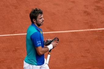 Switzerland's Stanislas Wawrinka holds his broken racket after throwing it during the men's final tennis match against Spain's Rafael Nadal at the Roland Garros 2017 French Open on June 11, 2017 in Paris.  / AFP PHOTO / Thomas SAMSON        (Photo credit 