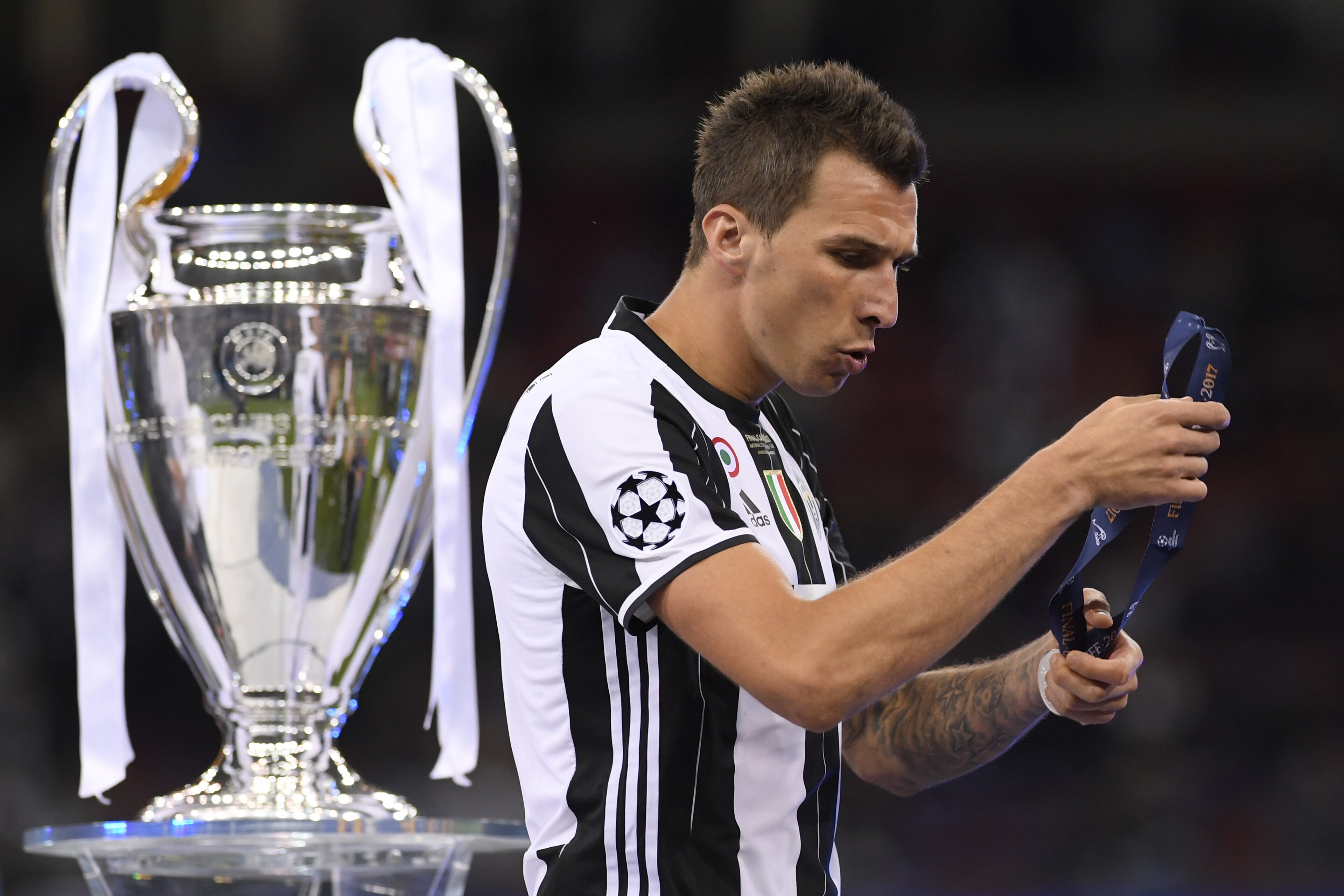 CARDIFF, WALES - JUNE 03: Mario Mandzukic of Juventus collects his runners up medal after the UEFA Champions League Final between Juventus and Real Madrid at National Stadium of Wales on June 3, 2017 in Cardiff, Wales.  (Photo by Matthias Hangst/Getty Ima