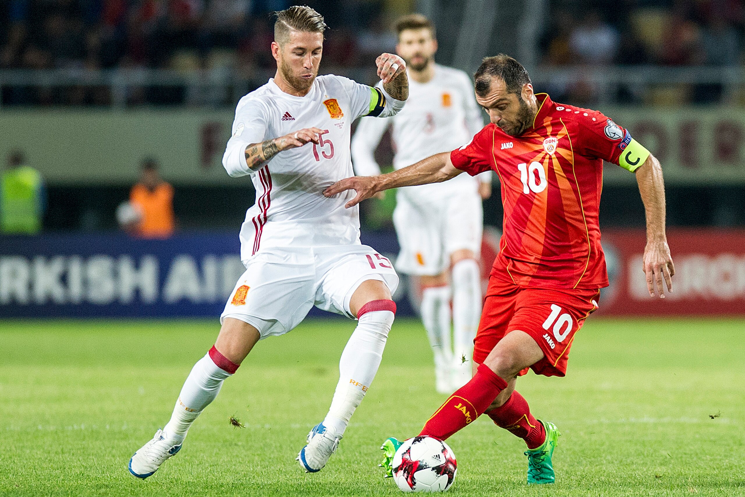 Spain's Sergio Ramos (L) tackles Macedonia's Goran Pandev during the FIFA World Cup 2018 qualifying football match between Macedonia and Spain at Philip II of Macedon Stadium in Skopje on June 11, 2017. / AFP PHOTO / Robert ATANASOVSKI        (Photo credi