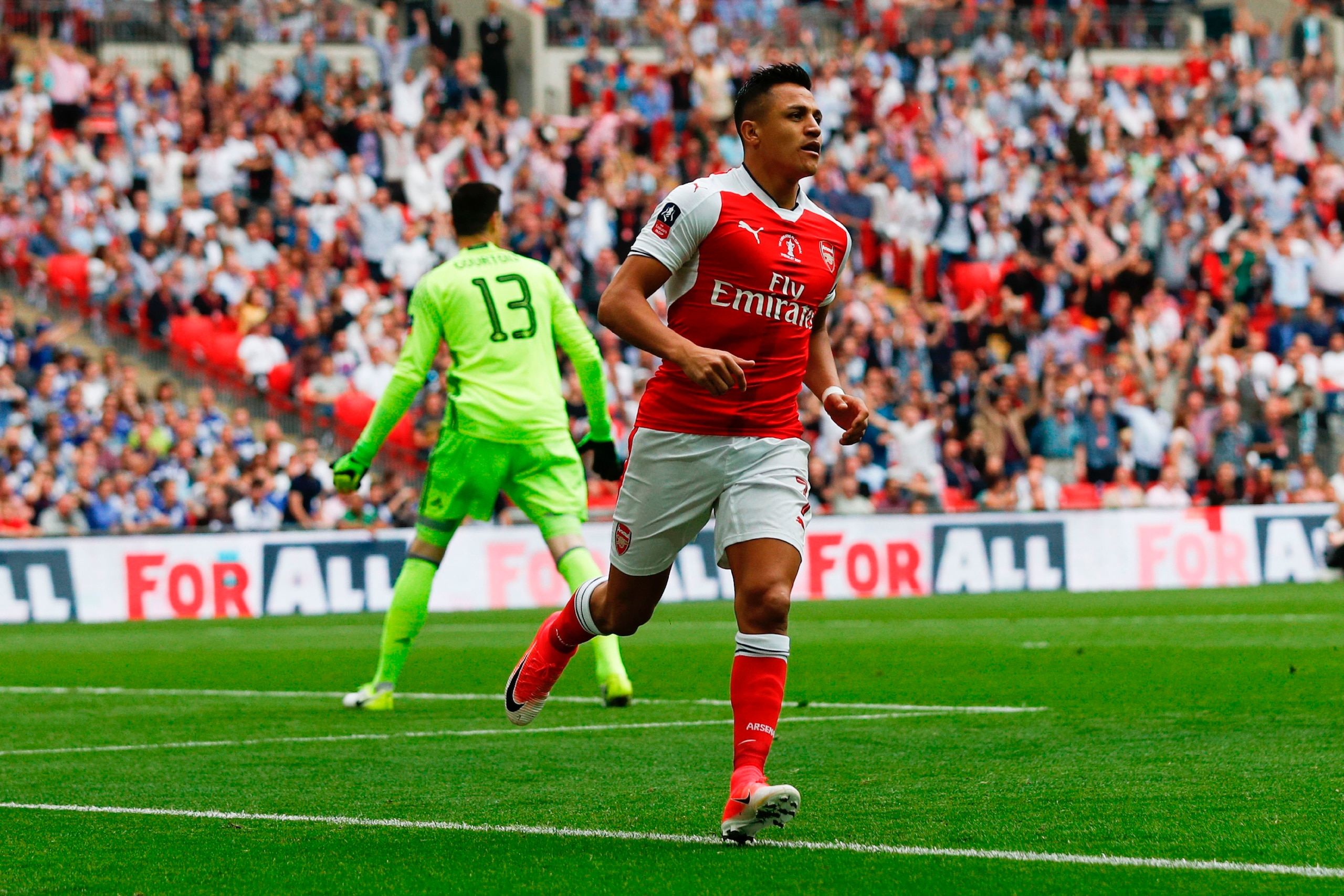 Arsenal's Chilean striker Alexis Sanchez (R) celebrates after scoring the opening goal of the English FA Cup final football match between Arsenal and Chelsea at Wembley stadium in London on May 27, 2017. / AFP PHOTO / Adrian DENNIS / NOT FOR MARKETING OR 