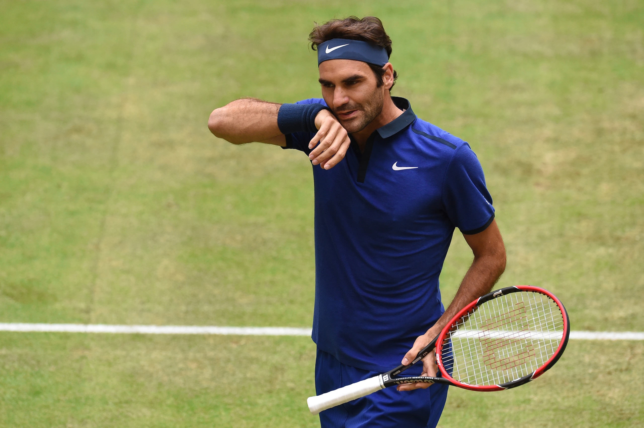 Roger Federer of Switzerland reacts during the ATP tour tennis match against Alexander Zverev of Germany (unseen), in Halle, western Germany, on June 18, 2016.  / AFP / CARMEN JASPERSEN        (Photo credit should read CARMEN JASPERSEN/AFP/Getty Images)