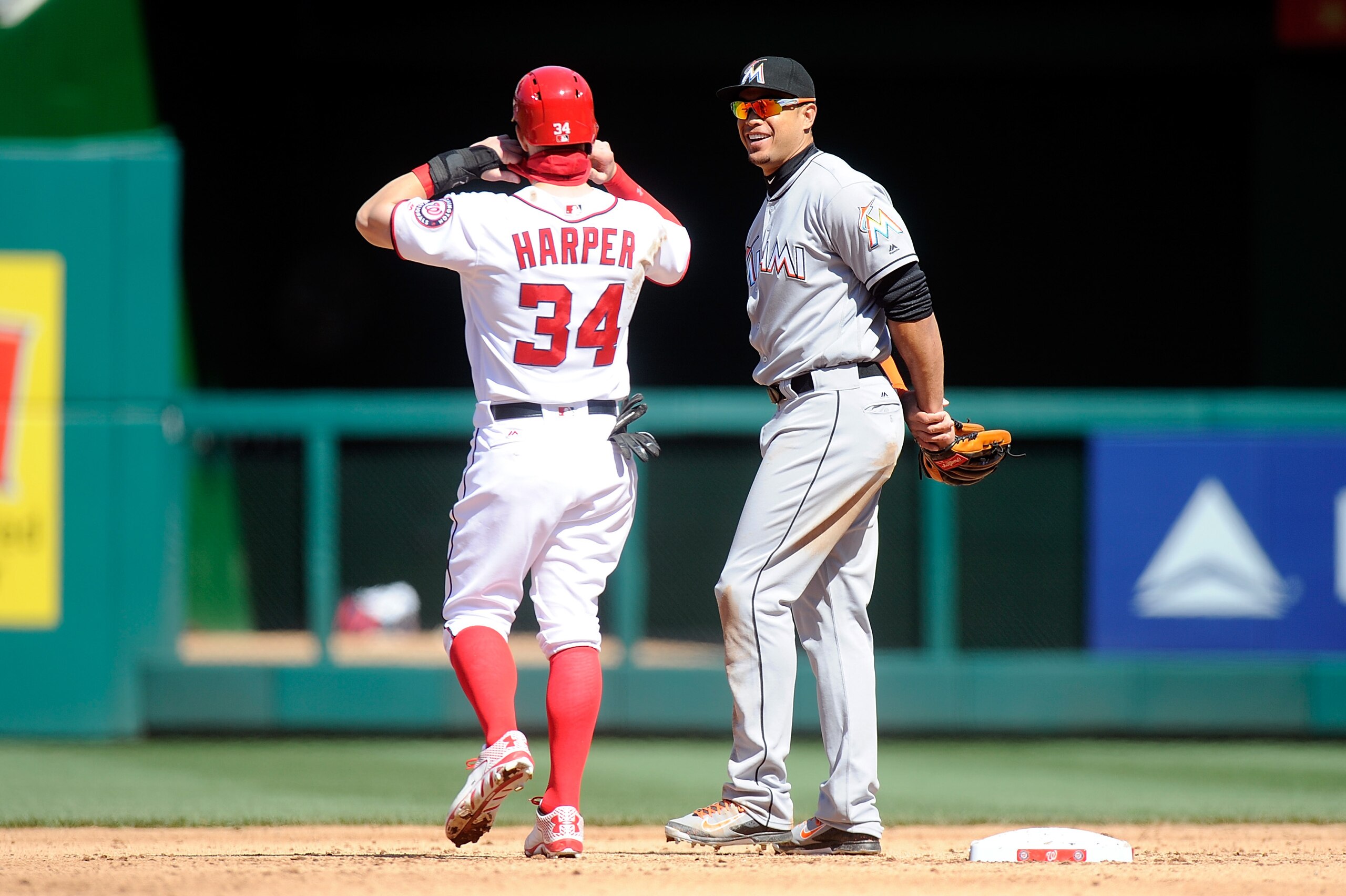 WASHINGTON, DC - APRIL 10:  Bryce Harper #34 of the Washington Nationals talks with Giancarlo Stanton #27 of the Miami Marlins during a play review in the fifth inning at Nationals Park on April 10, 2016 in Washington, DC.  (Photo by Greg Fiume/Getty Imag