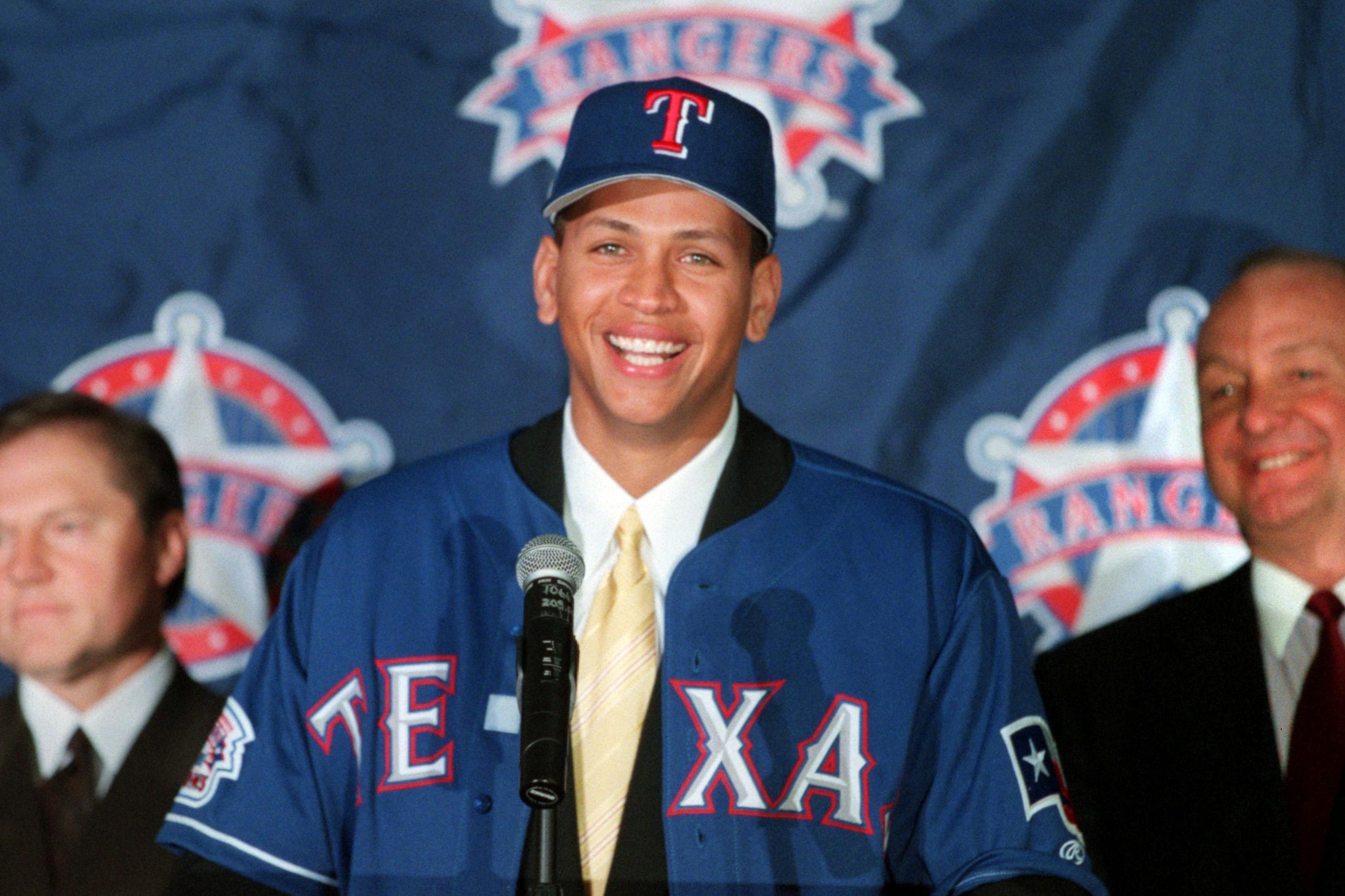12 Dec 2000:  Newly signed Texas Ranger Alex Rodriguez, center, is introduced to the media by club owner Tom Hicks, right, and Rodriguez' agent Scott Boras during a press conference at The Ballpark in Arlington, Texas. Mandatory Credit: Gary Barber/ALLSPO