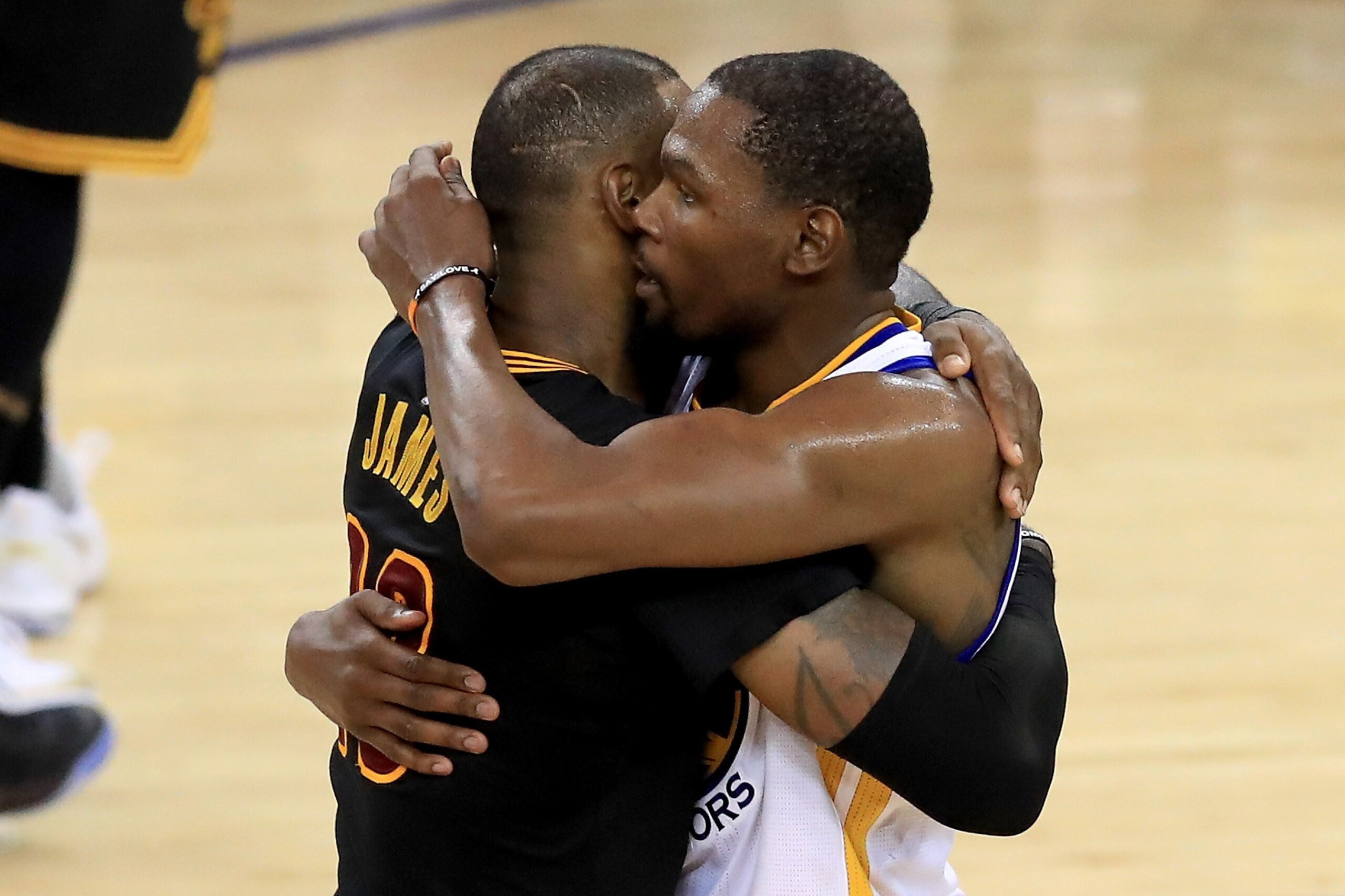 OAKLAND, CA - JUNE 12:  Kevin Durant #35 of the Golden State Warriors hugs LeBron James #23 of the Cleveland Cavaliers after defeating the Cleveland Cavaliers 129-120 in Game 5 to win the 2017 NBA Finals at ORACLE Arena on June 12, 2017 in Oakland, Califo