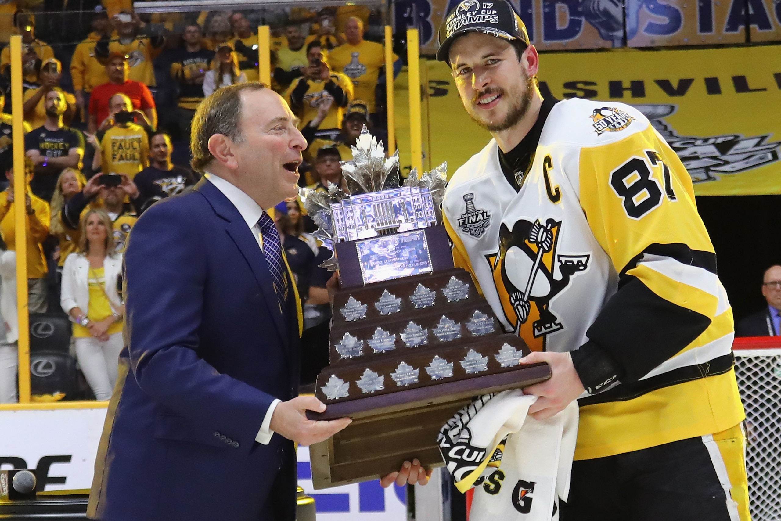 NASHVILLE, TN - JUNE 11: Sidney Crosby #87 of the Pittsburgh Penguins is awarded the Conn Smythe trophy  as presented by NHL commissioner Gary Bettman following Game Six of the 2017 NHL Stanley Cup Final at the Bridgestone Arena on June 11, 2017 in Nashvi