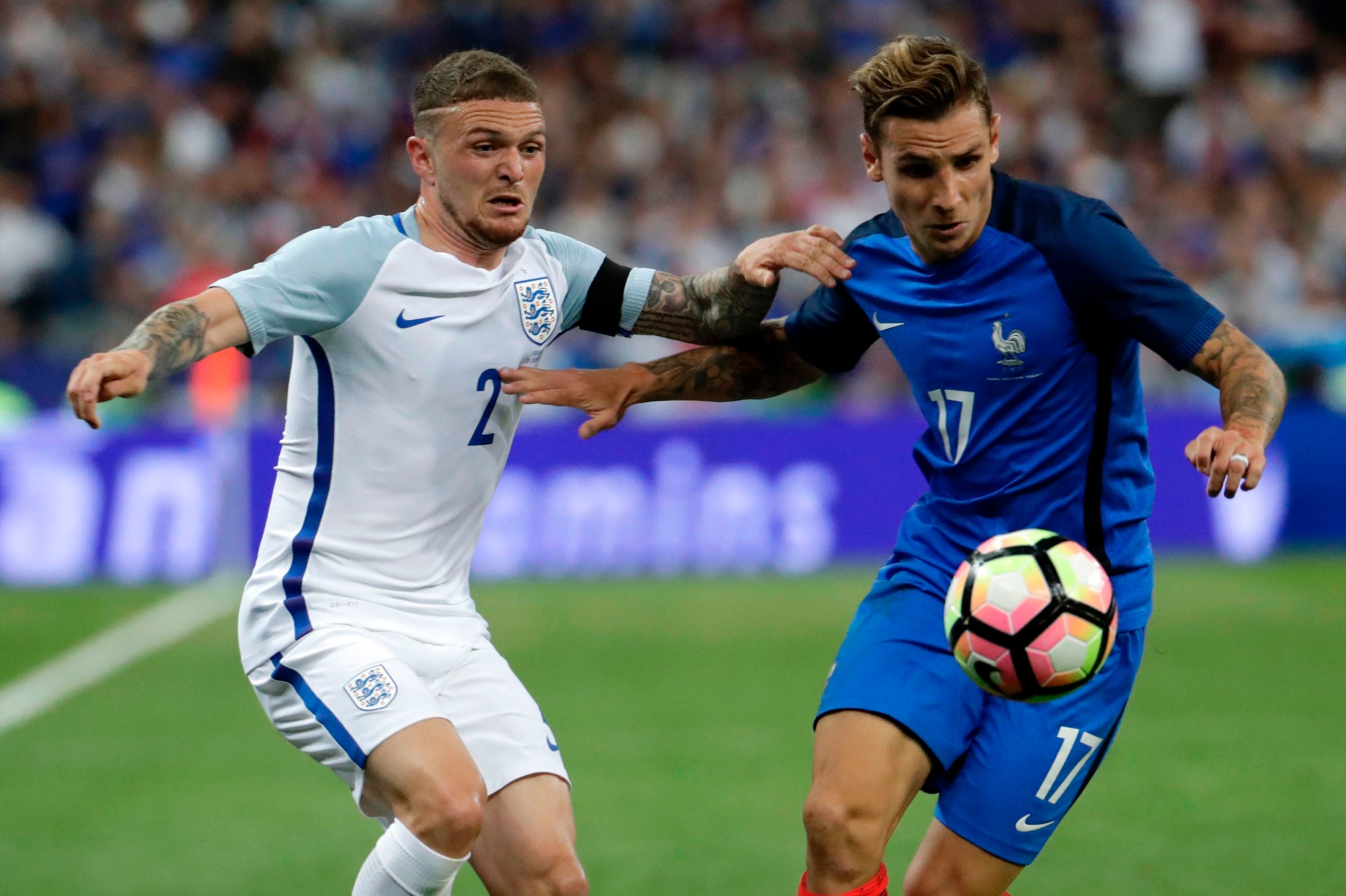 France's defender Lucas Digne (R) and England's defender Kieran Trippier fight for the ball during the international friendly football match between France and England at The Stade de France Stadium in Saint-Denis near Paris on June 13, 2017.             