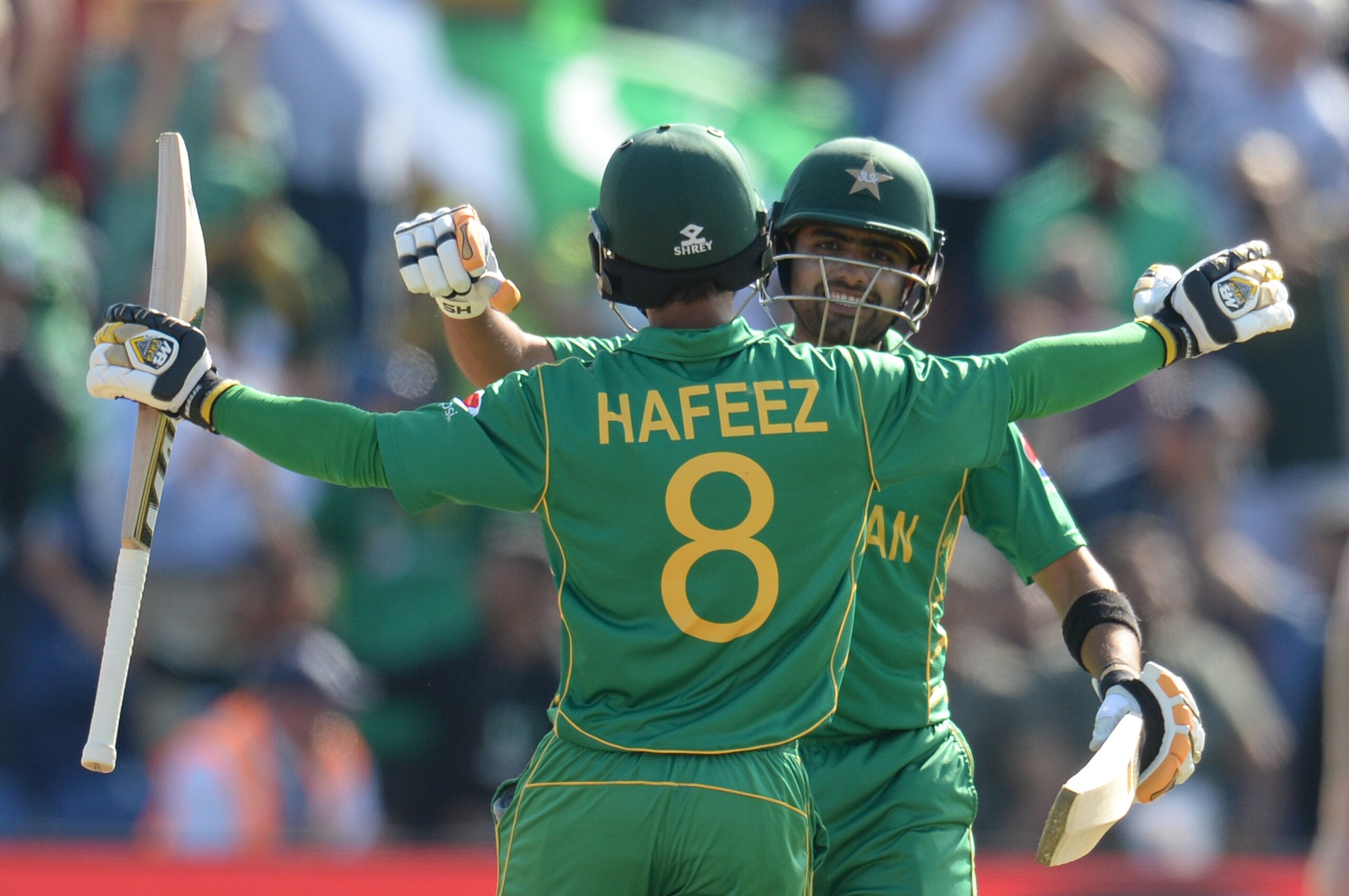 CARDIFF, WALES - JUNE 14 : Babar Azam and Mohammad Hafeez of Pakistan embrace after winning the ICC Champions Trophy match between England and Pakistan at Swalec stadium on June 14, 2017 in Cardiff, Wales. (Photo by Philip Brown/Getty Images)