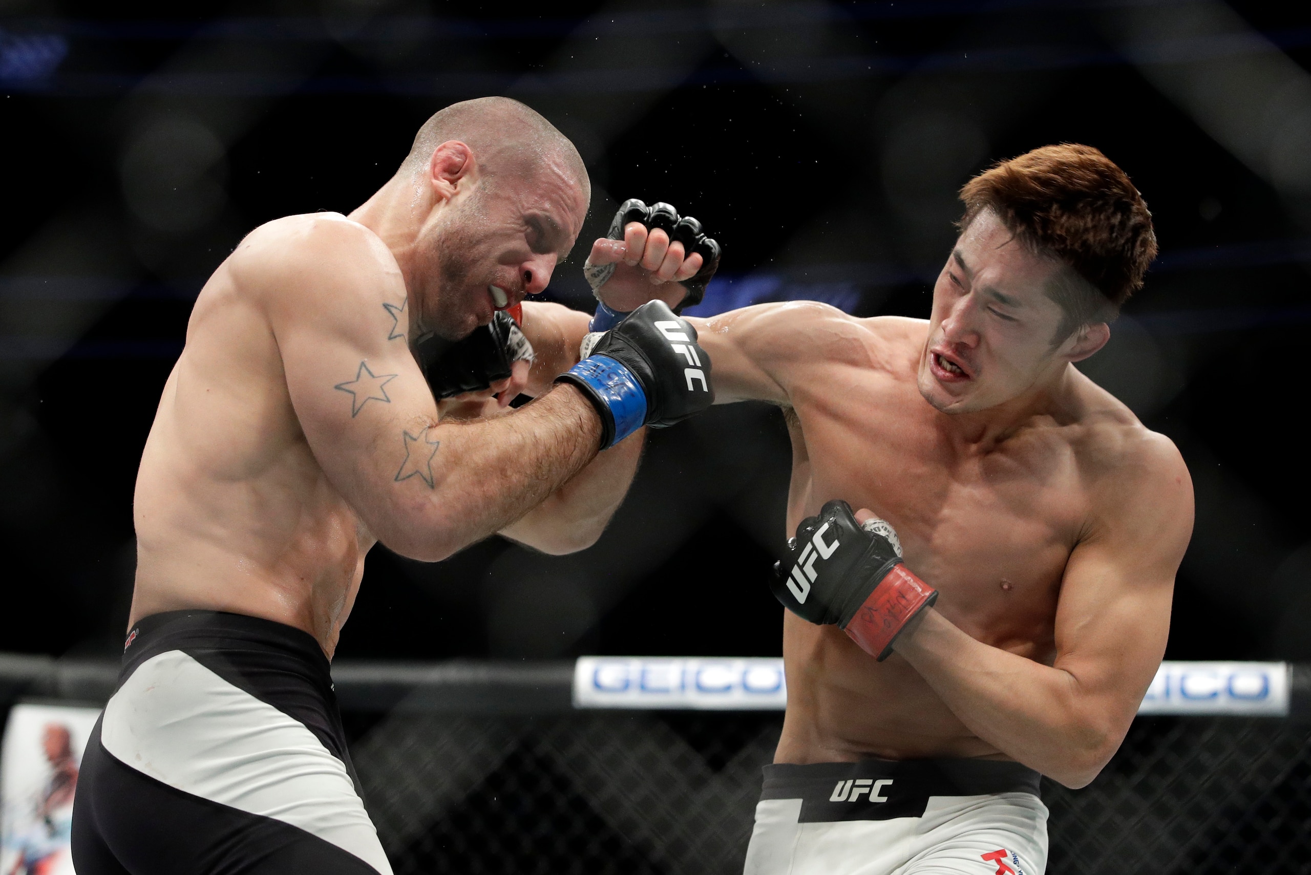 Dong Hyun Kim (right) hits Tarec Saffiedine.