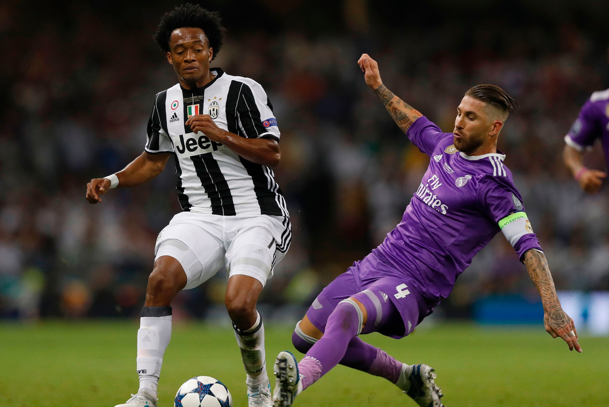 Real Madrid's Spanish defender Sergio Ramos (R) tackles Juventus' Colombian midfielder Juan Cuadrado during the UEFA Champions League final football match between Juventus and Real Madrid at The Principality Stadium in Cardiff, south Wales, on June 3, 201