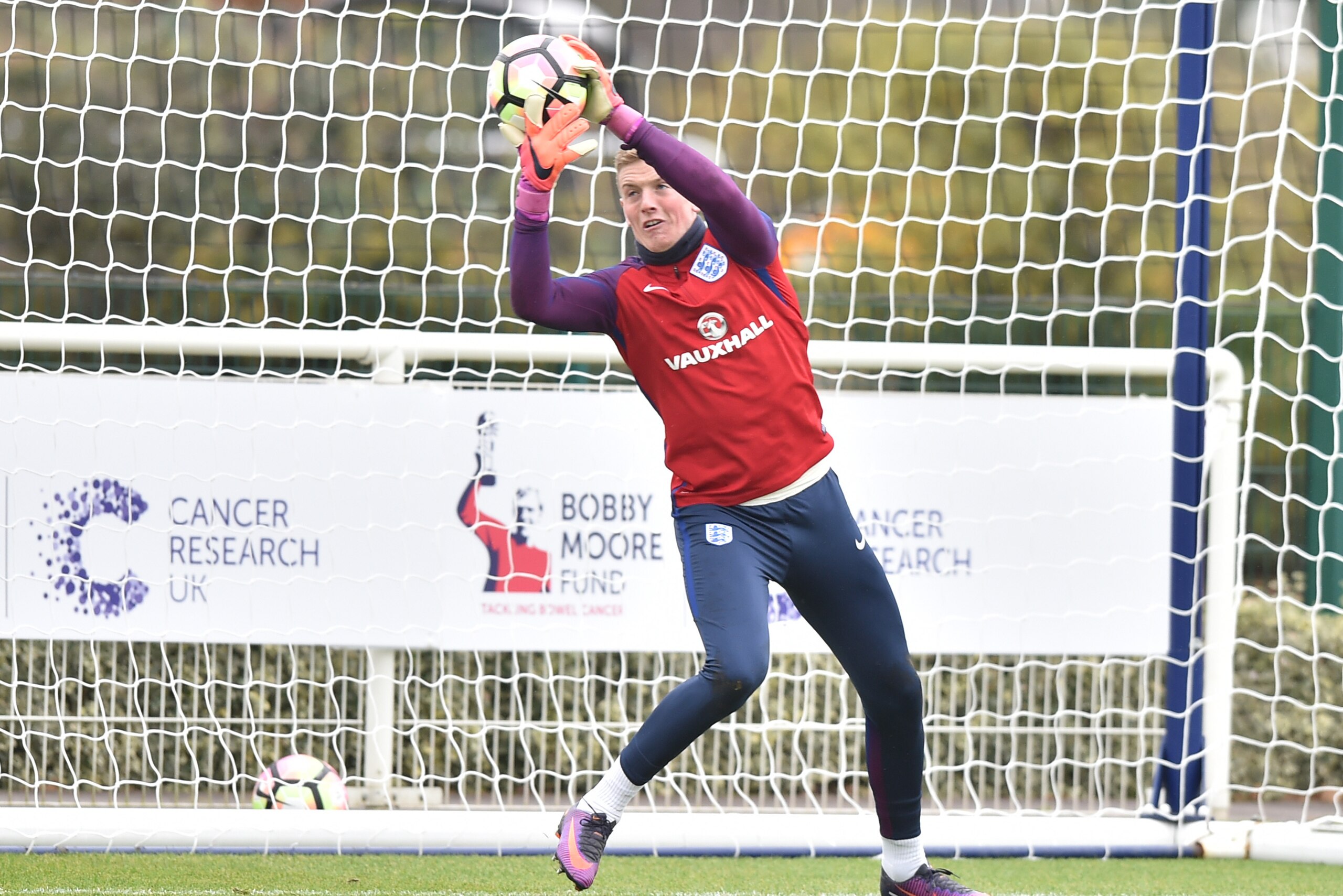 England's goalkeeper Jordan Pickford makes a save during a training session at Tottenham Hotspur's training ground in north London on November 14, 2016 ahead of their international friendly football match against Spain on November 15. / AFP / OLLY GREENWO