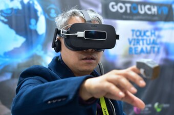 An attendee samples VR Touch from GoTouchVR, a wearable haptic ring creating the illusion of touching virtual objects, designed and available for a large variety of applications, is displayed at the 2017 Consumer Electronic Show (CES) in Las Vegas, Nevada
