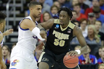 KANSAS CITY, MO - MARCH 23: Caleb Swanigan #50 of the Purdue Boilermakers is defended by Landen Lucas #33 of the Kansas Jayhawks during the 2017 NCAA Men's Basketball Tournament Midwest Regional at Sprint Center on March 23, 2017 in Kansas City, Missouri.