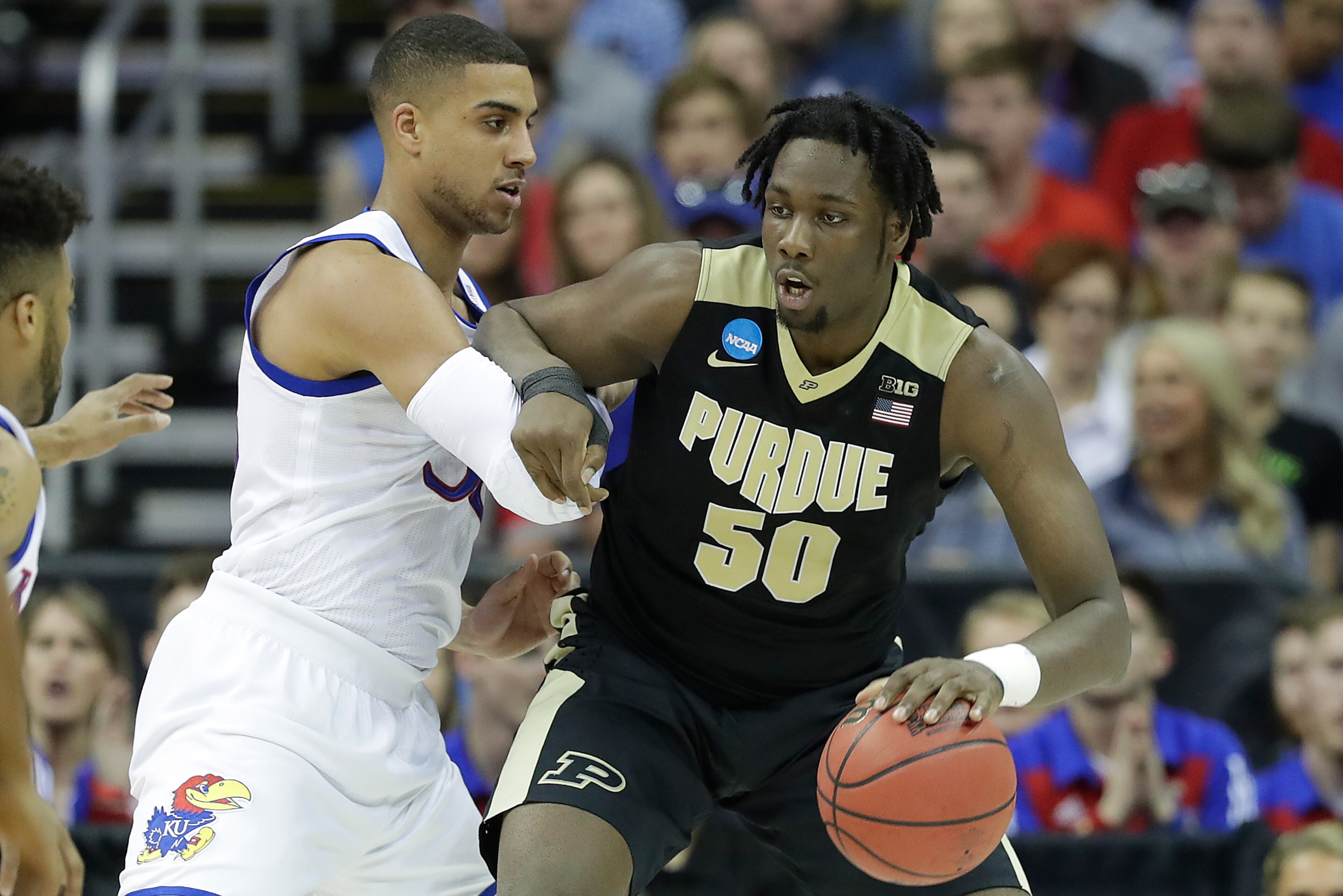 KANSAS CITY, MO - MARCH 23: Caleb Swanigan #50 of the Purdue Boilermakers is defended by Landen Lucas #33 of the Kansas Jayhawks during the 2017 NCAA Men's Basketball Tournament Midwest Regional at Sprint Center on March 23, 2017 in Kansas City, Missouri. KANSAS CITY, MO - MARCH 23: Caleb Swanigan #50 of the Purdue Boilermakers is defended by Landen Lucas #33 of the Kansas Jayhawks during the 2017 NCAA Men's Basketball Tournament Midwest Regional at Sprint Center on March 23, 2017 in Kansas City, Missouri.