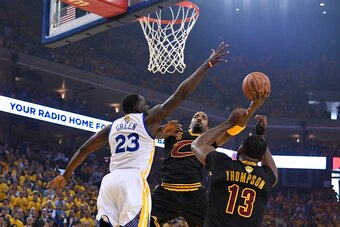 Jun 12, 2017; Oakland, CA, USA; Cleveland Cavaliers guard JR Smith (5) shoots against Golden State Warriors forward Draymond Green (23) during the first quarter in game five of the 2017 NBA Finals at Oracle Arena. Mandatory Credit: Kyle Terada-USA TODAY S