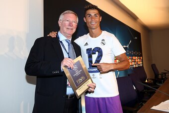 CARDIFF, WALES - JUNE 03:  In this handout image provided by UEFA, Cristiano Ronaldo of Real Madrid poses with the Man of the Match award and Sir Alex Ferguson after the UEFA Champions League Final between Juventus and Real Madrid at National Stadium of W