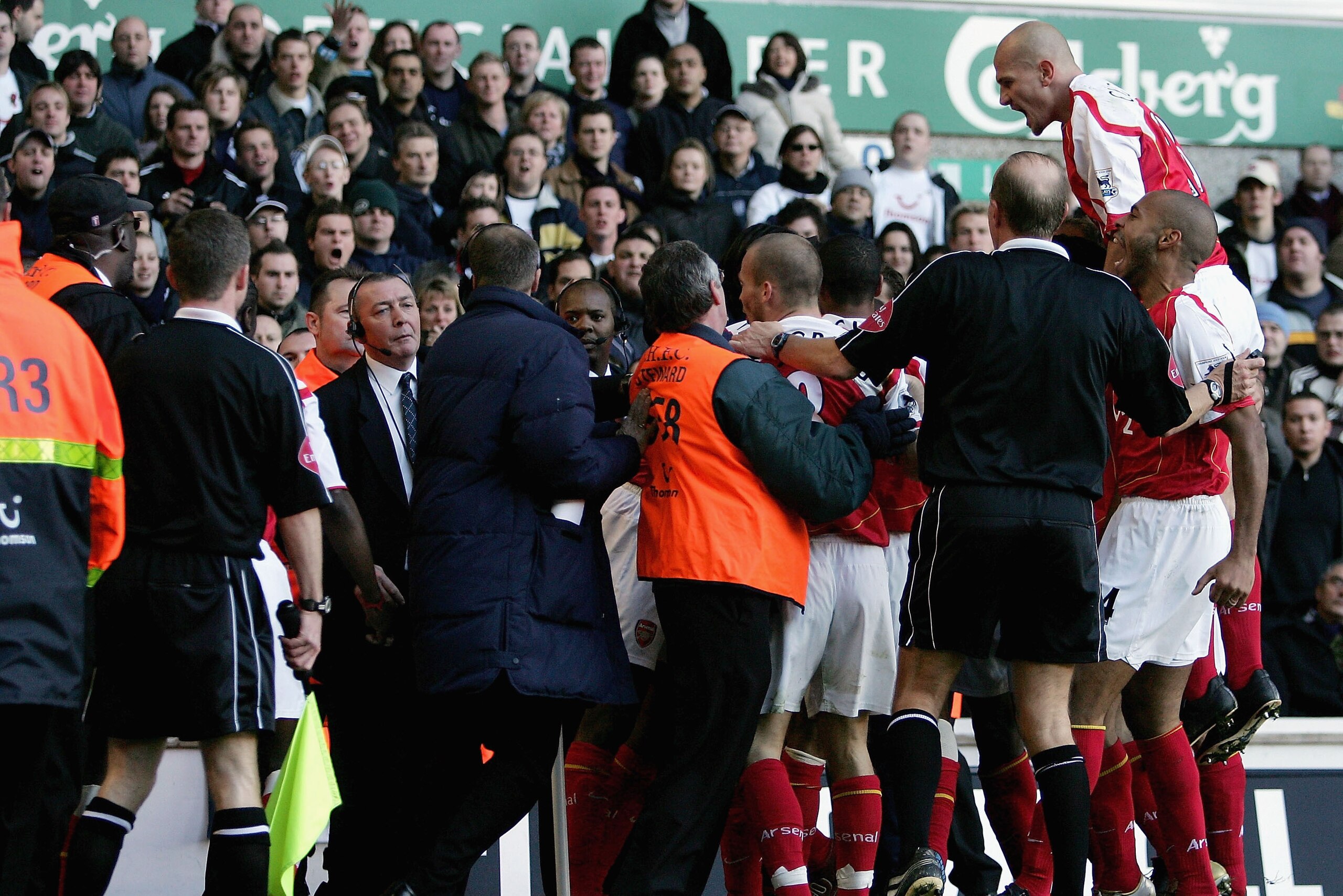 LONDON - NOVEMBER 13:  Stewards hold back Arsenal's players as they celebrate Lauren's goal during the Barclays Premiership match between Tottenham Hotspur and Arsenal at White Hart Lane on November 13, 2004 in London, England.  (Photo by Ian Walton/Getty