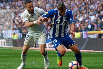 MADRID, SPAIN - APRIL 02:  Daniel Carvajal (L) of Real Madrid competes for the ball with Theo Hernandez of Deportivo Alaves during the La Liga match between Real Madrid and Deportivo Alaves at Estadio Santiago Bernabeu on April 2, 2017 in Madrid, Spain.  