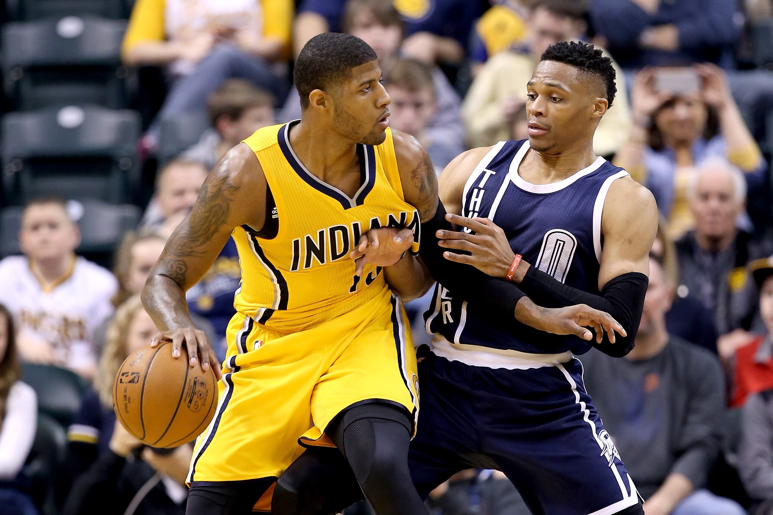 INDIANAPOLIS, IN - MARCH 19:  Paul George #13 of the Indiana Pacers dribbles the ball while defended by Russell Westbrook #0 of the Oklahoma City Thunder at Bankers Life Fieldhouse on March 19, 2016 in Indianapolis, Indiana.   NOTE TO USER: User expressly