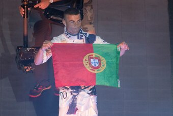 Real Madrid's Portuguese forward Cristiano Ronaldo holds up a Prtugeuse flag during a celebration event held at the Santiago Bernabeu stadium after the team won the the UEFA Champions League football match final Juventus vs Real Madrid CF held at the Nati